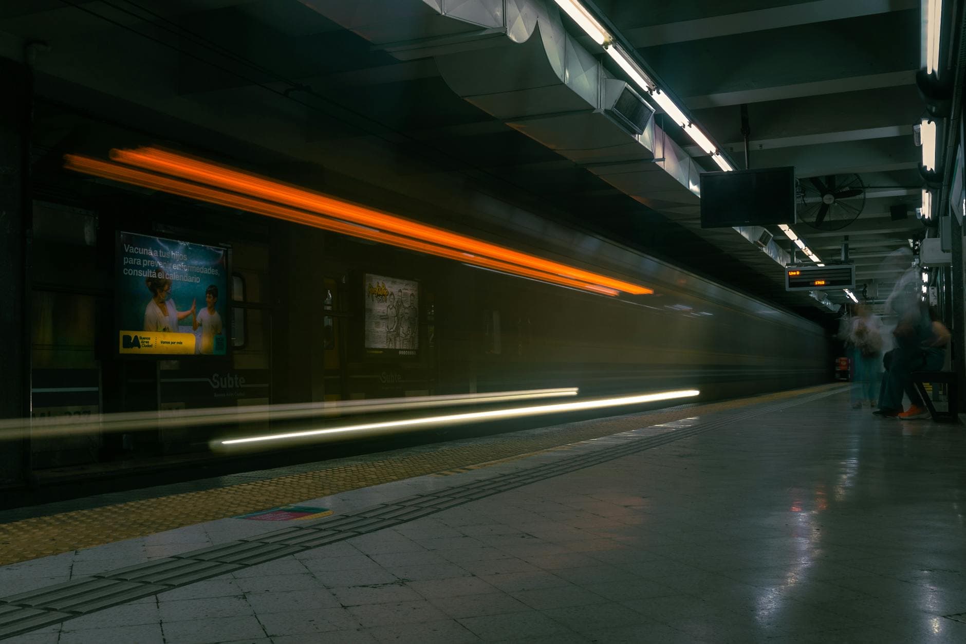 A dynamic long exposure shot of a subway train at Buenos Aires station showcasing motion blur.