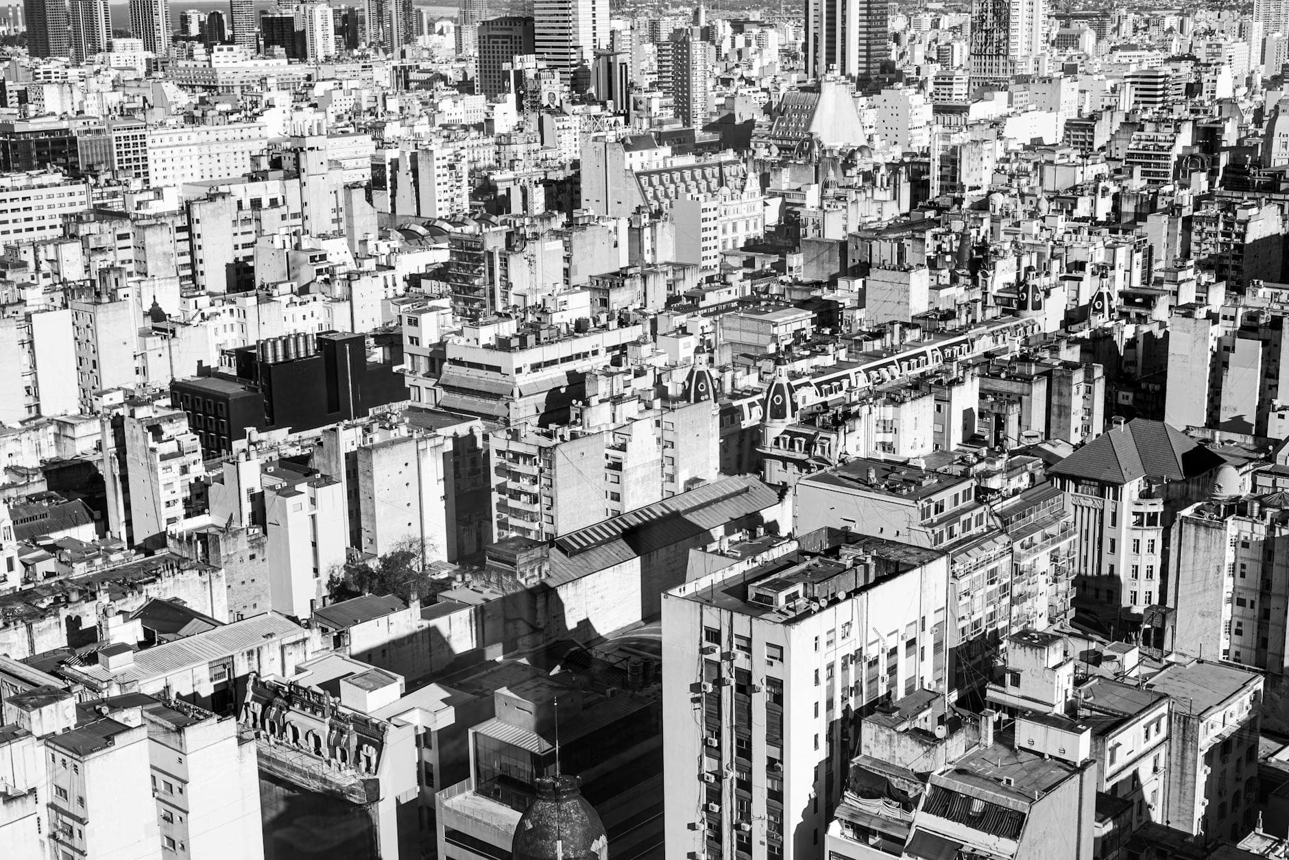 A stunning black and white aerial view of Buenos Aires, showcasing its dense urban landscape.