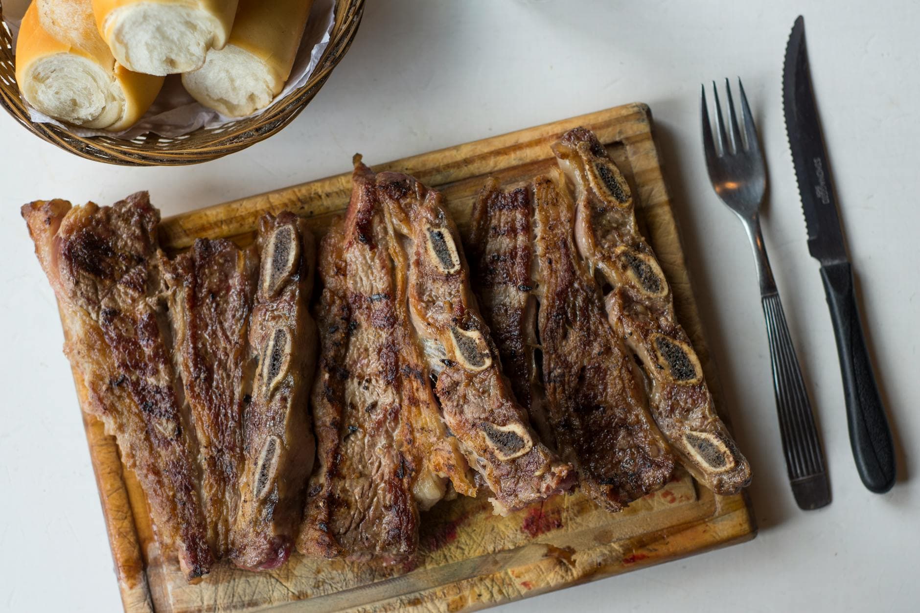 Delicious traditional Argentine asado, grilled steaks with bread, perfect for a classic meal.
