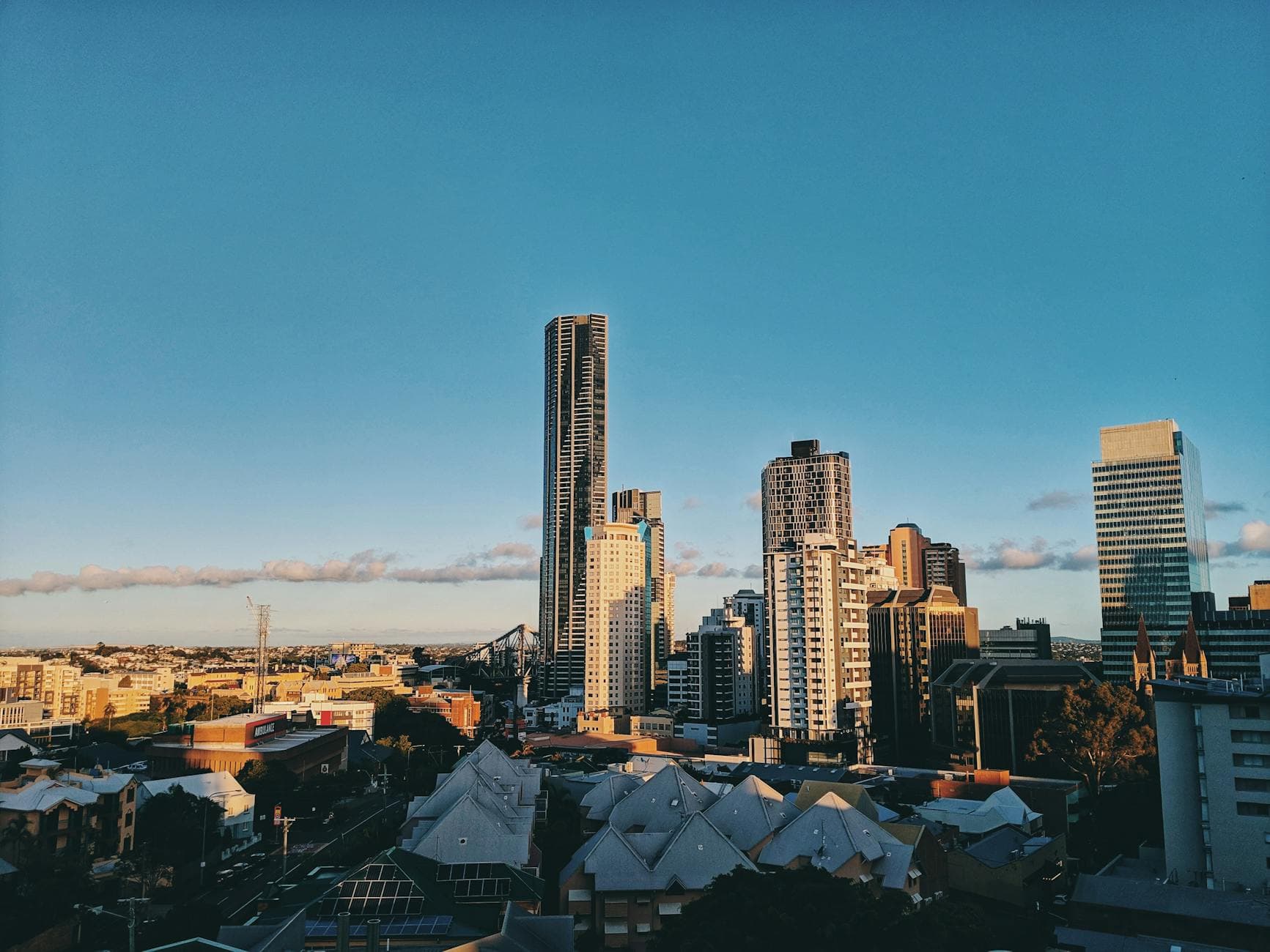 A stunning view of Brisbane's modern skyline featuring towering skyscrapers against a clear blue sky.