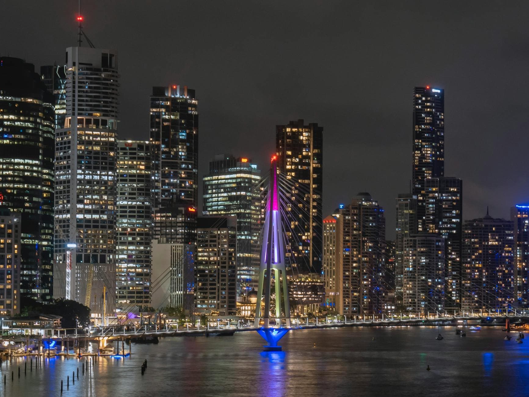 Breathtaking view of Brisbane's illuminated skyline and iconic bridge at night, Australia.