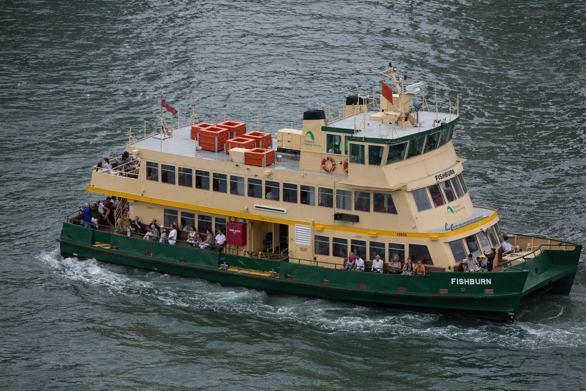 A bustling Sydney Harbour ferry carrying passengers across the scenic waters, an iconic transport in Australia.