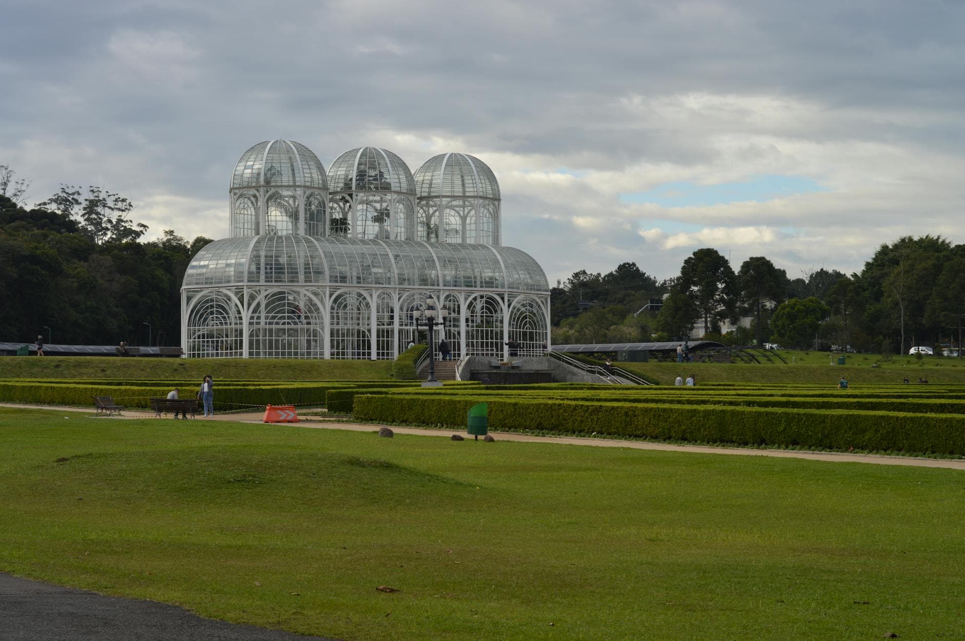 Stunning glasshouse at Curitiba's botanical garden under cloudy skies, Paraná, Brazil.
