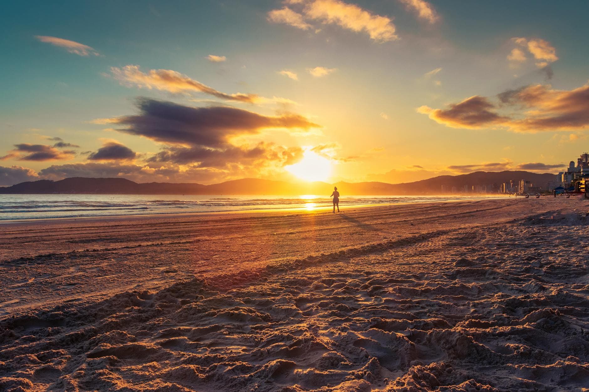 Capture the serene beauty of a sunrise over Itapema beach, Brazil. Perfect for tranquil scenery.