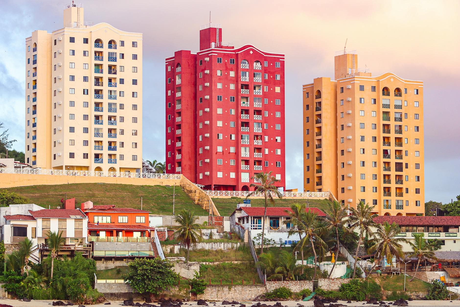 Colorful high-rise buildings overlooking a tropical beach in Natal, Brazil, showcasing urban coastal architecture.