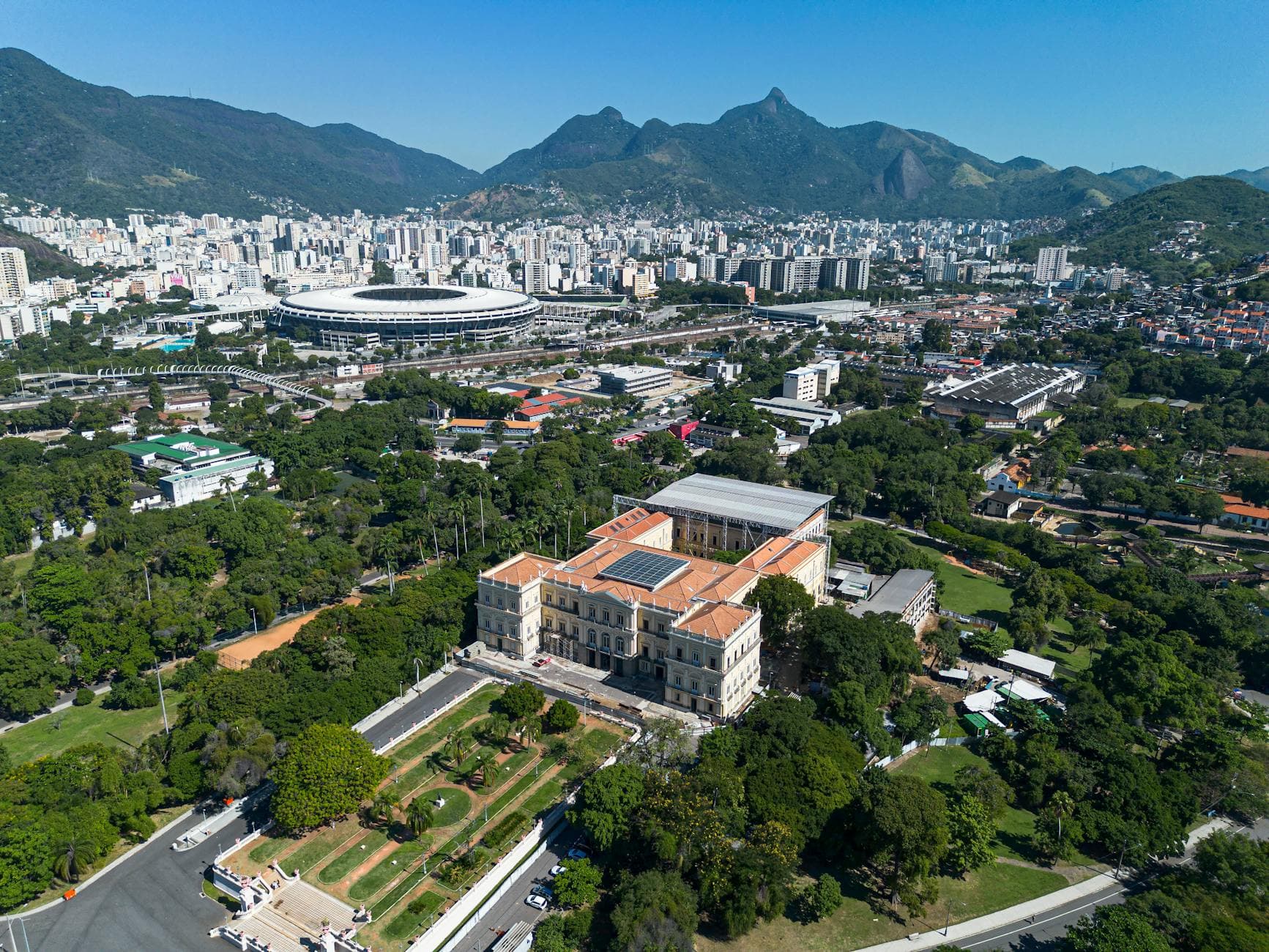 Stunning aerial view of Rio's Maracanã Stadium and cityscape in clear daylight.