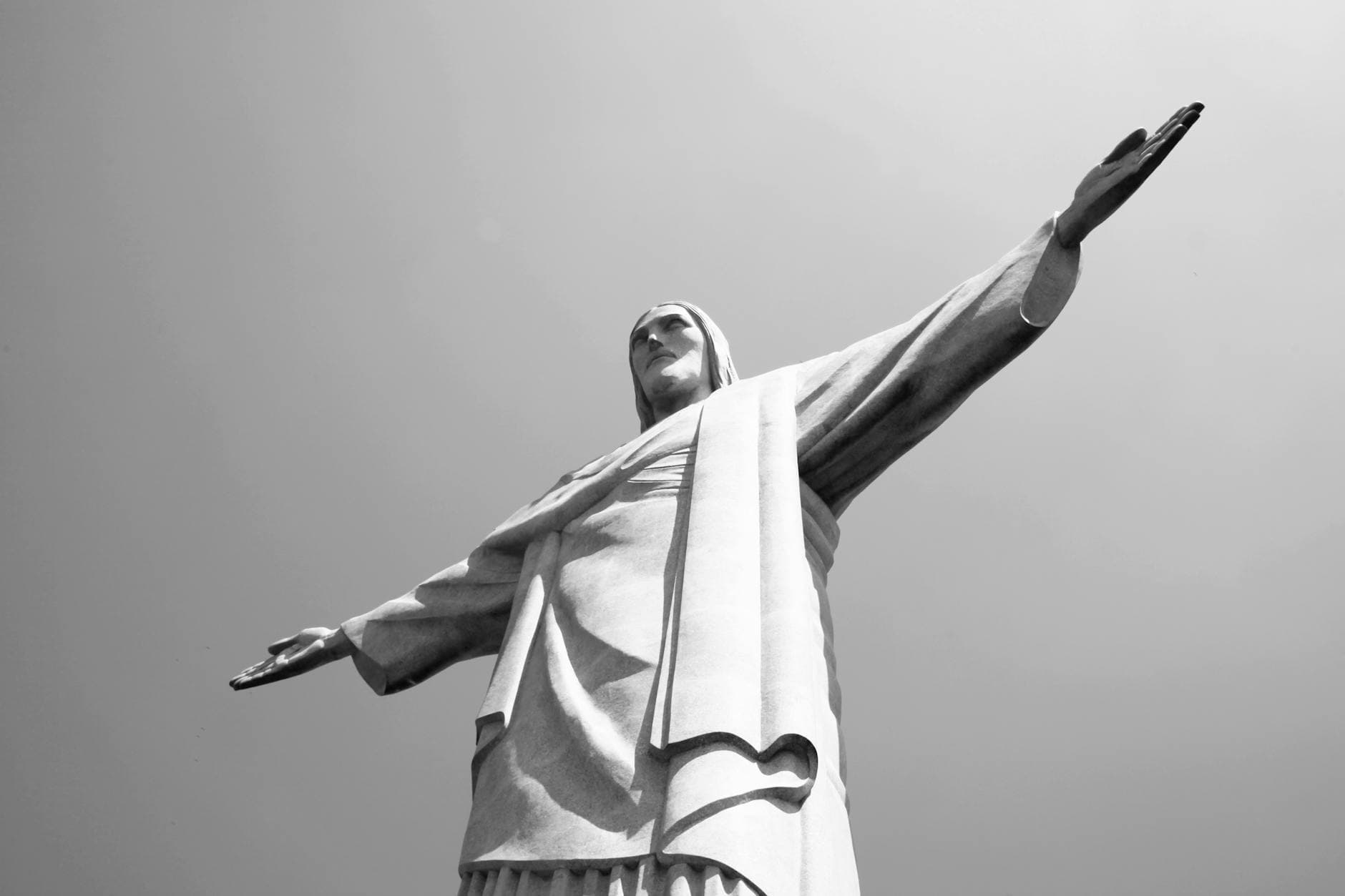 Black and white photo of Christ the Redeemer statue in Rio de Janeiro, Brazil.