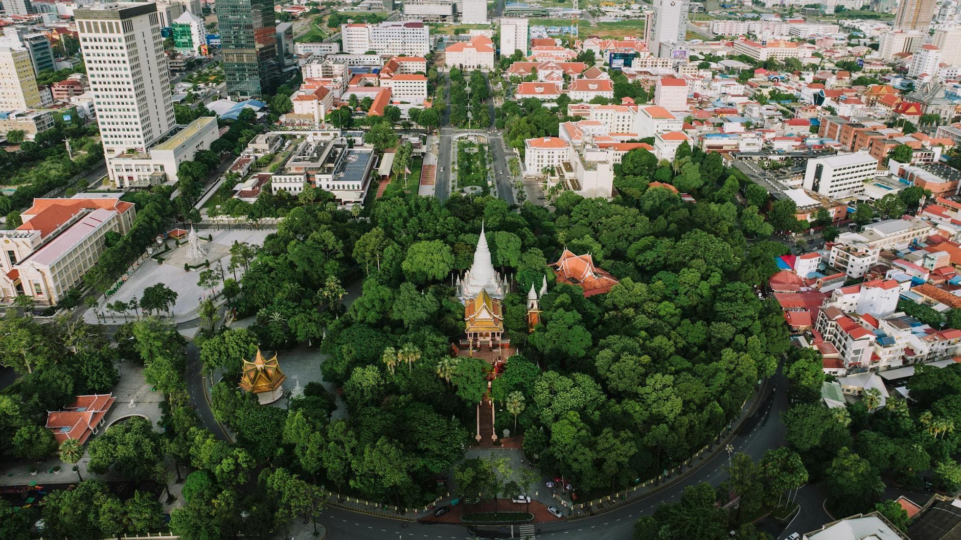 Drone shot of Wat Phnom surrounded by urban landscape in Phnom Penh, Cambodia.