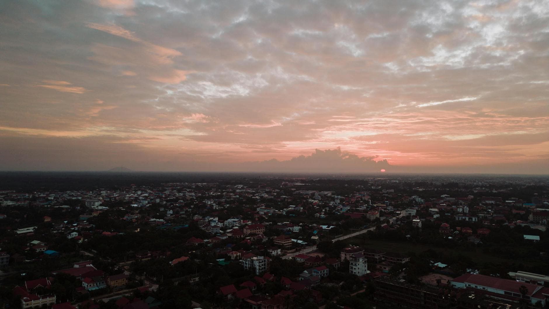 Captivating aerial view of Krong Siem Reap at sunset showing the cityscape and twilight sky.