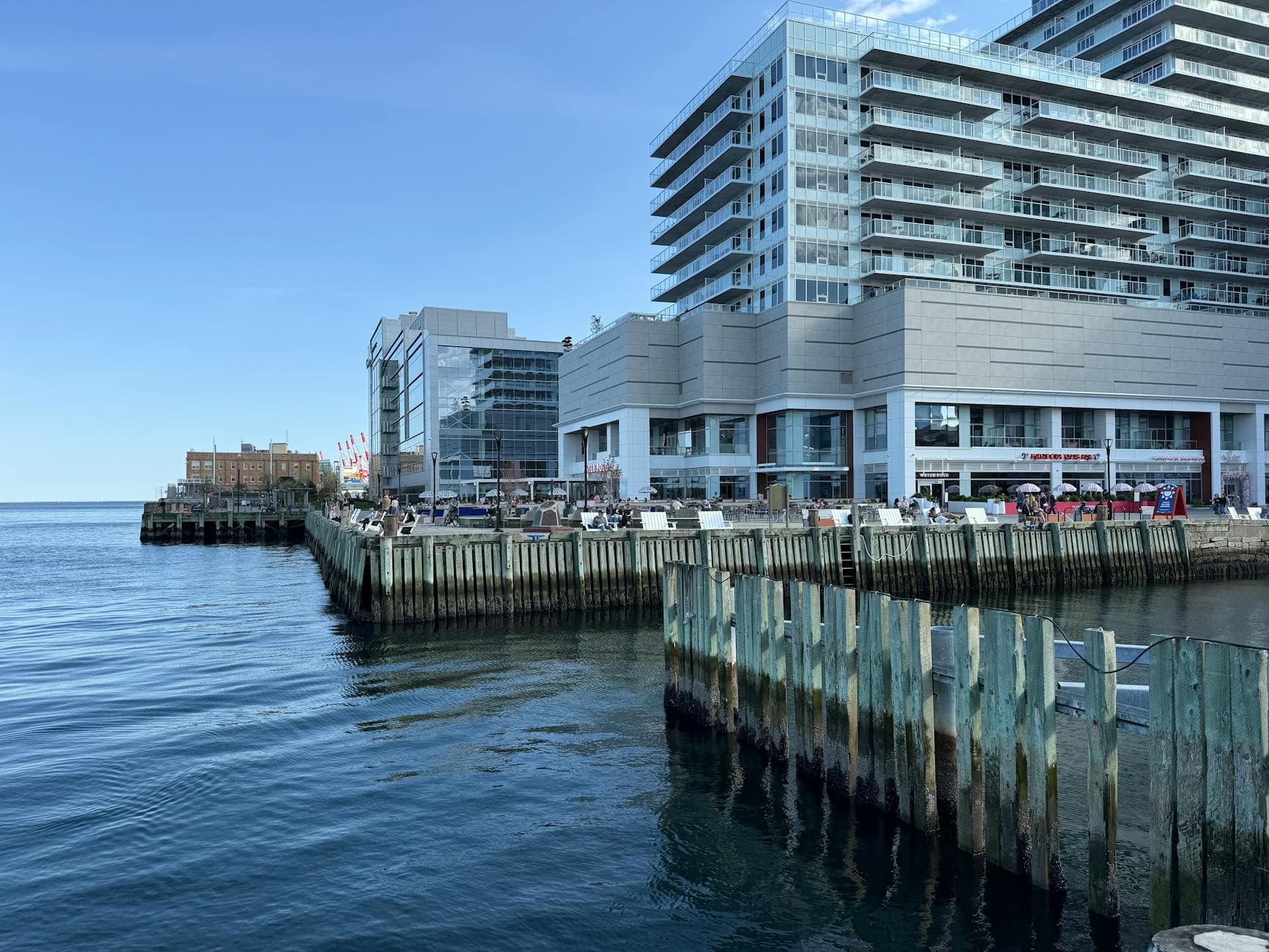 Contemporary waterfront architecture with dock, reflecting urban coastal life.