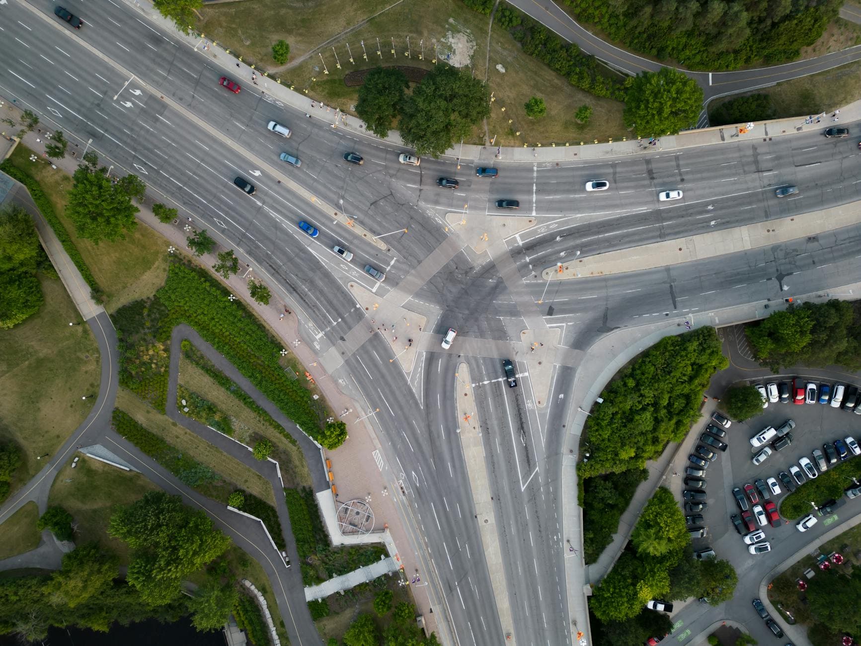 High-angle aerial shot of a busy road intersection in Ottawa, showcasing urban traffic and greenery.