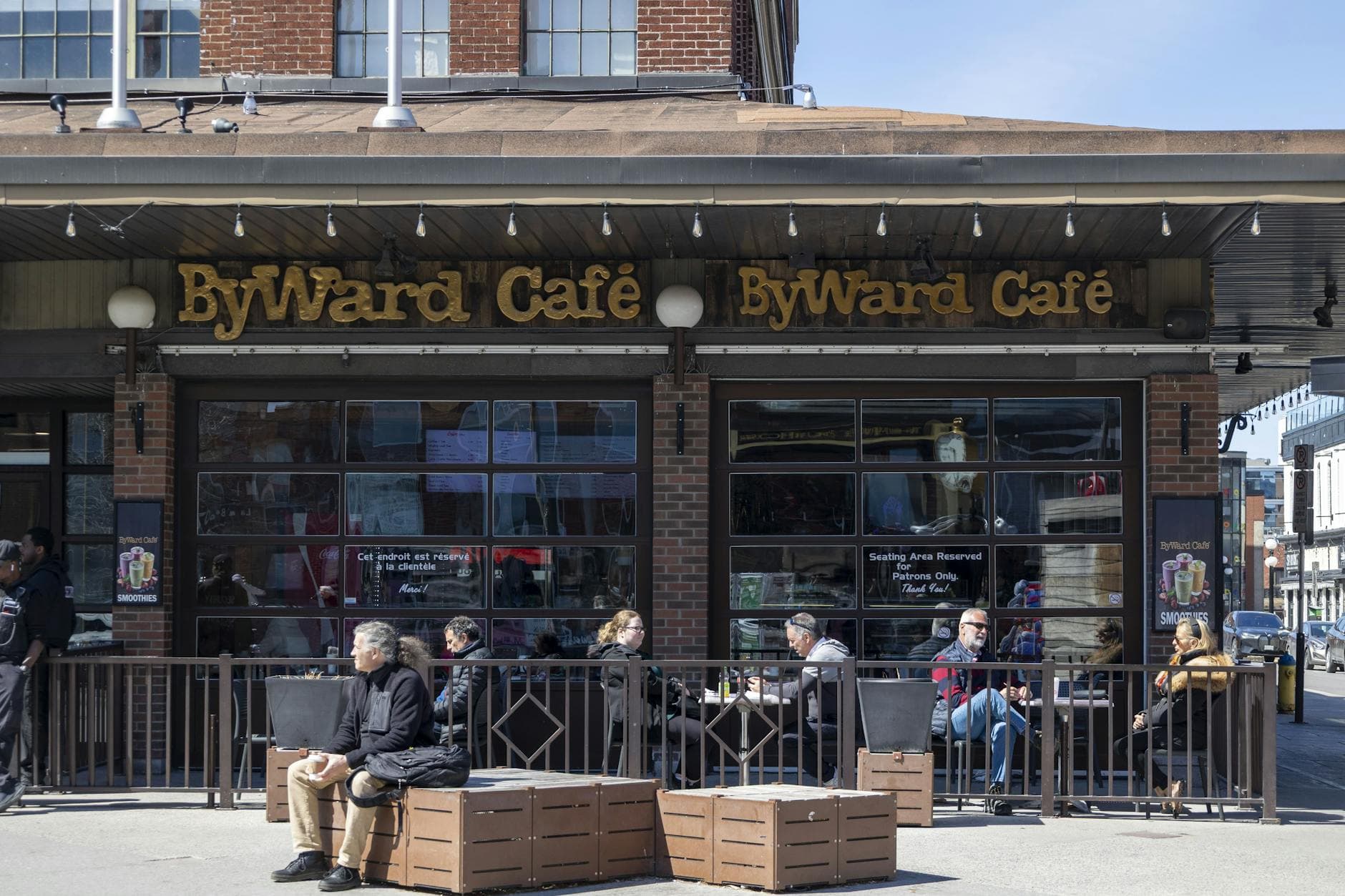 People enjoying a sunny day at ByWard Café in Ottawa with outdoor seating.