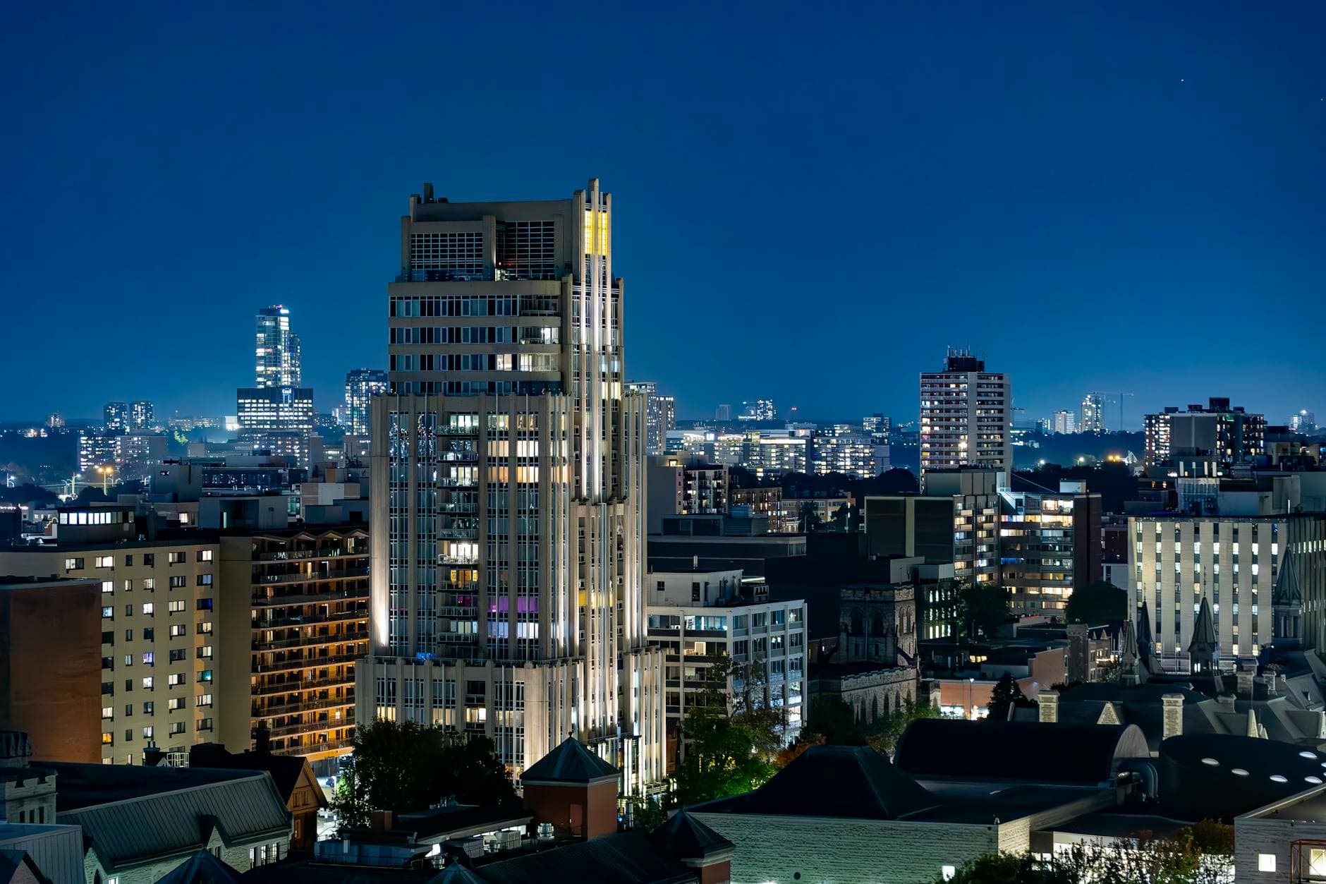 A stunning nighttime view of downtown Ottawa's illuminated skyscrapers.