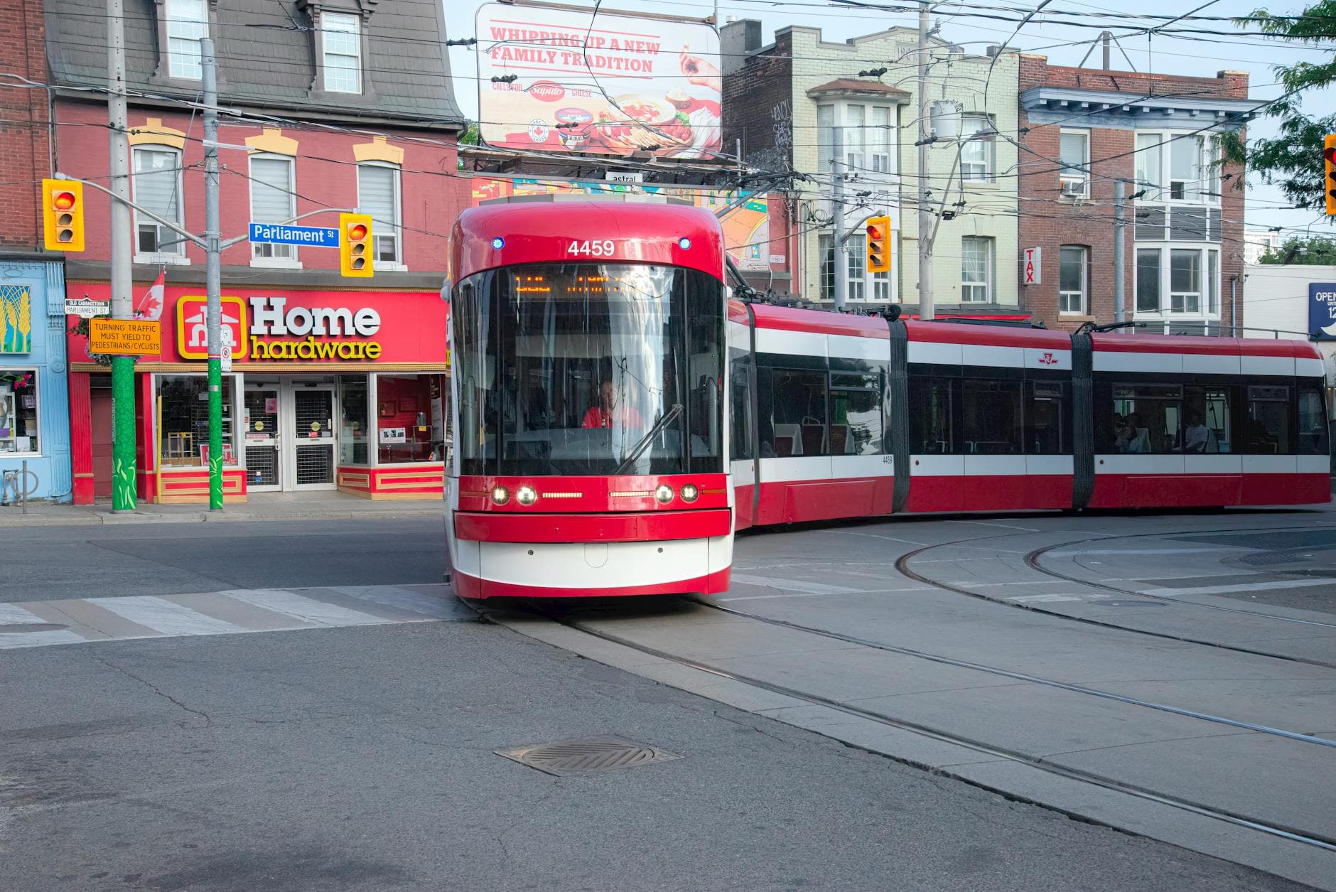 A streetcar traverses downtown Toronto near Parliament Street, showcasing urban transit.
