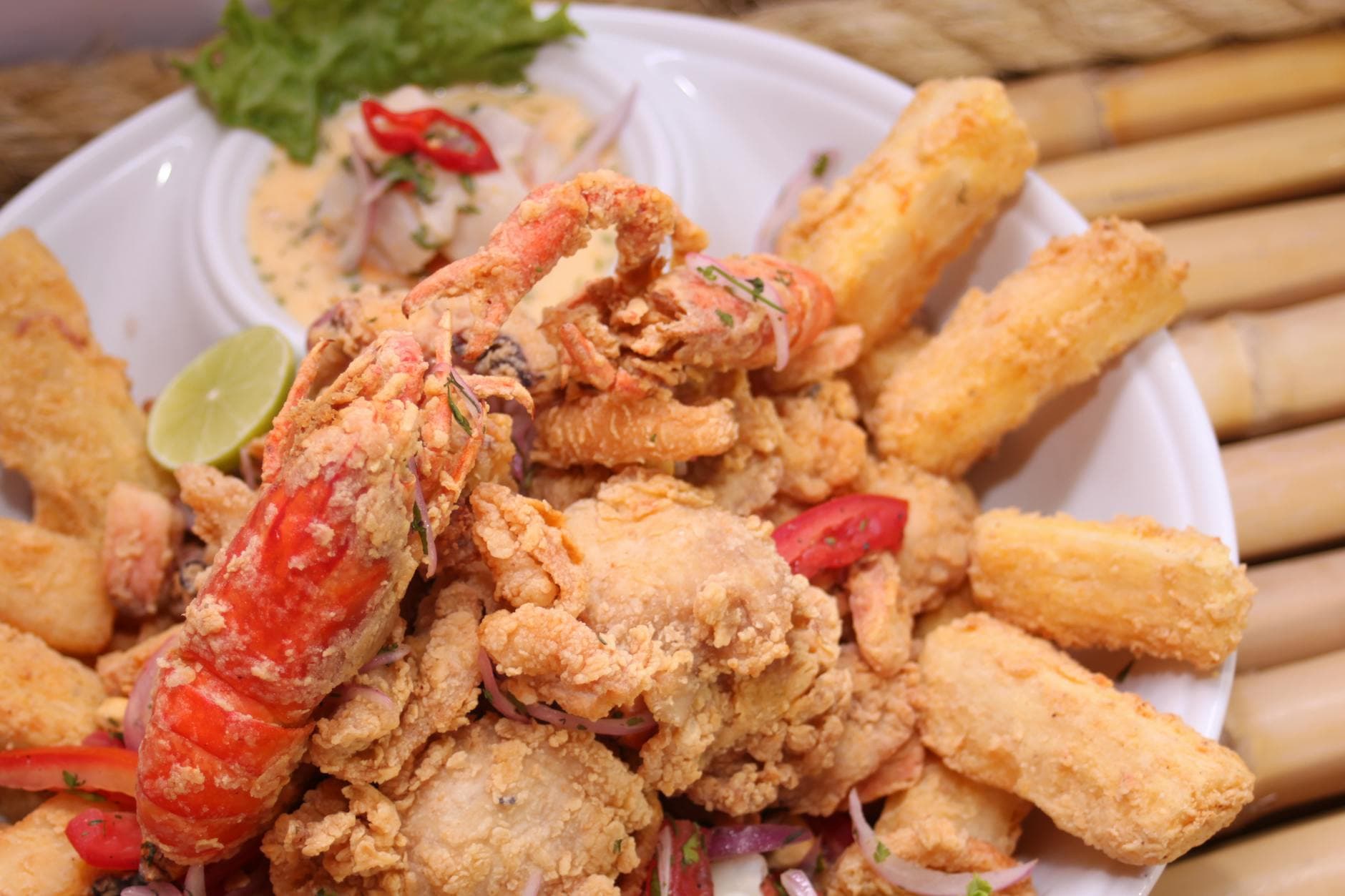 Delicious fried seafood platter with lobster and yuca fries, garnished with lime in Arequipa, Peru.