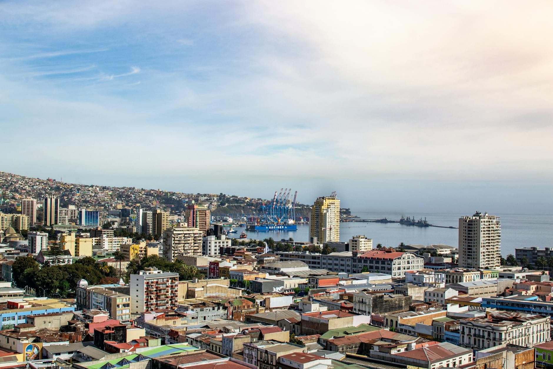 A scenic aerial view of Valparaíso, Chile, showcasing the city's vibrant architecture and bustling port.