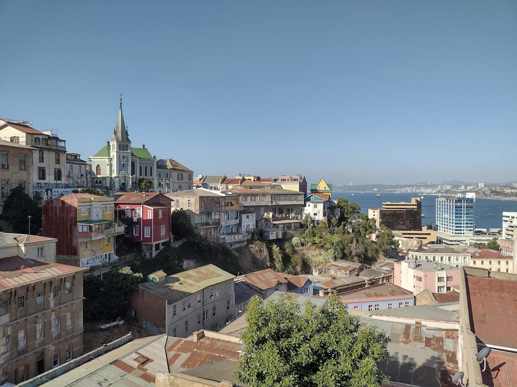 Colorful rooftops and iconic architecture of Valparaíso, Chile with a sea view.