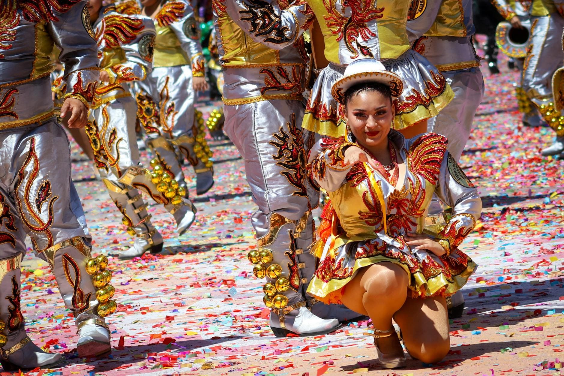 Vibrant parade with dancers in colorful costumes during a festival in Arica y Parinacota, Chile.