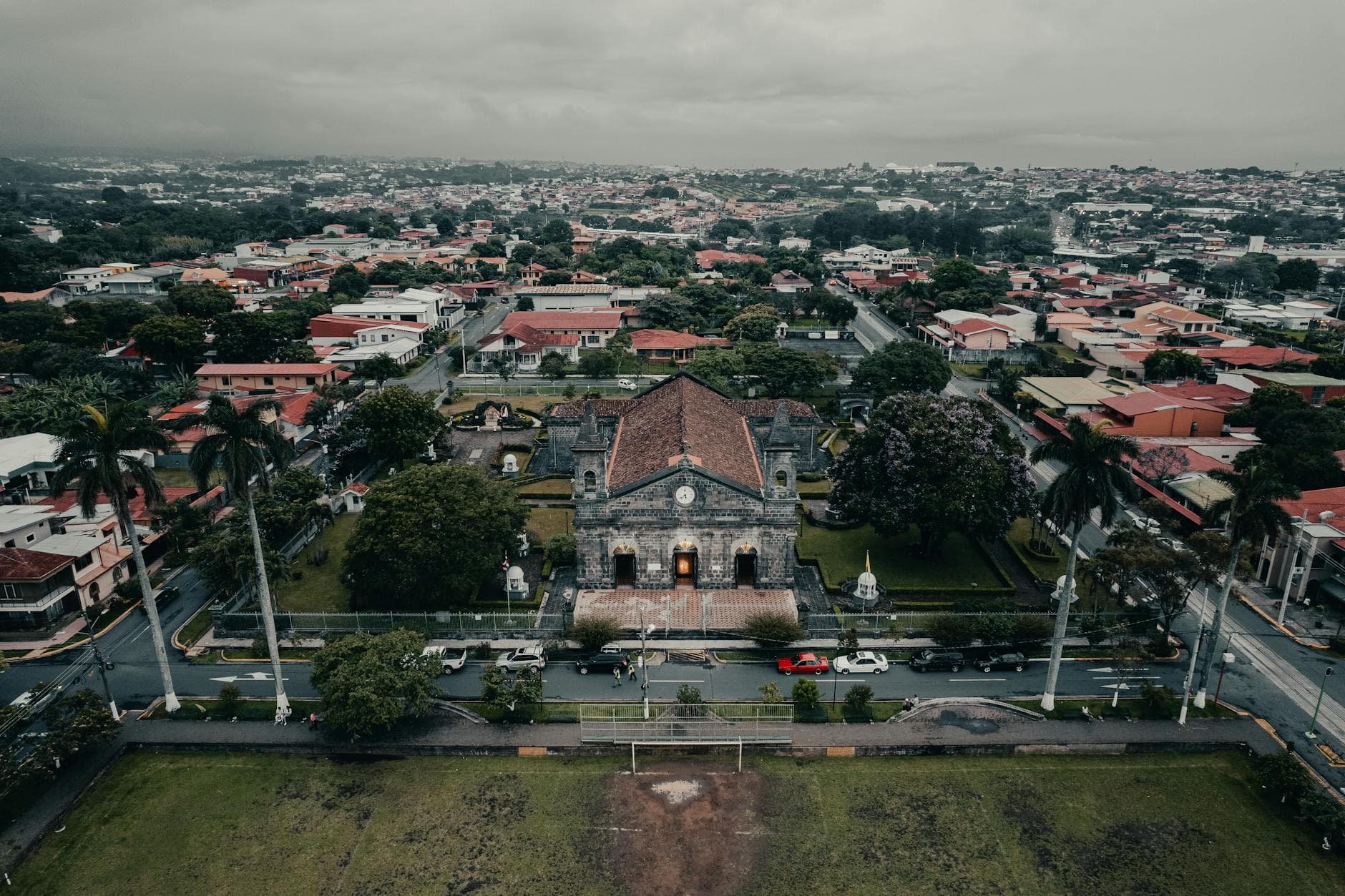 Scenic aerial view of a historic church surrounded by urban landscapes in Flores, Costa Rica.