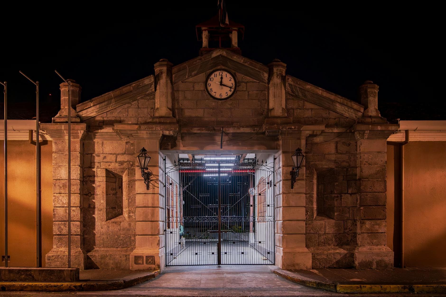 Night view of a historic building facade in San José, Costa Rica featuring a striking clock.