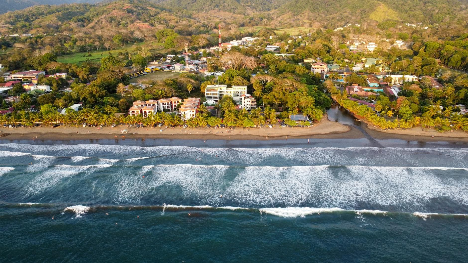 Stunning aerial view of Jaco Beach's coastline and townscape in Puntarenas, Costa Rica.