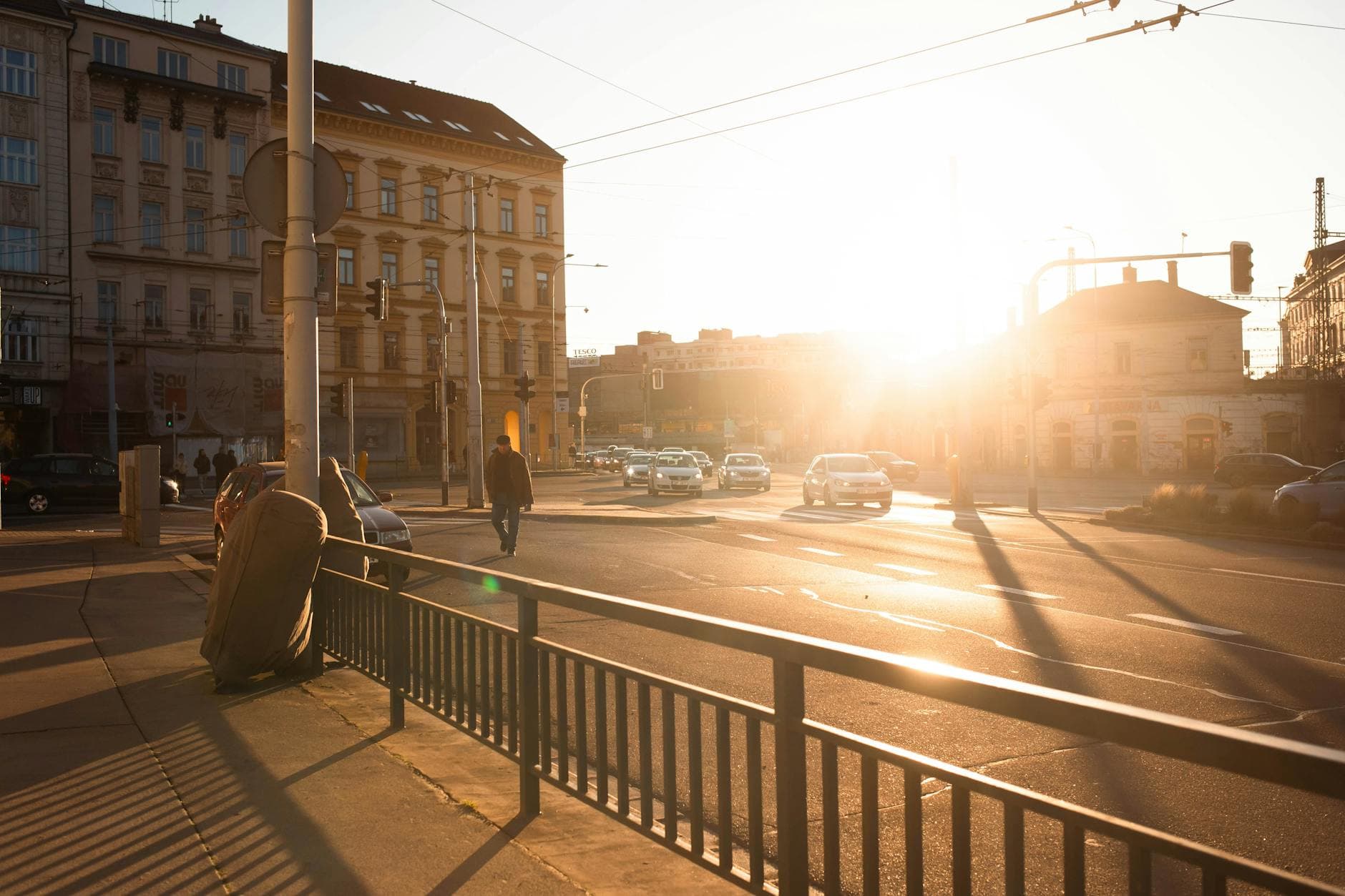 A vibrant sunset over an urban street in Brno, capturing architectural details and daily life.
