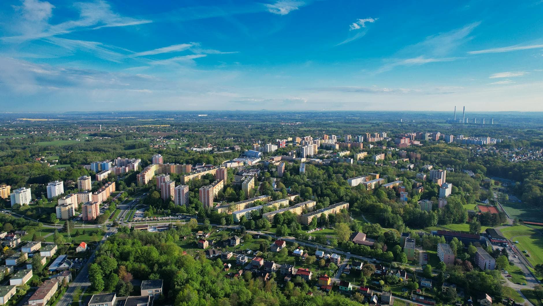 Aerial view of Orlová, Czech Republic, showcasing urban development amidst lush greenery.