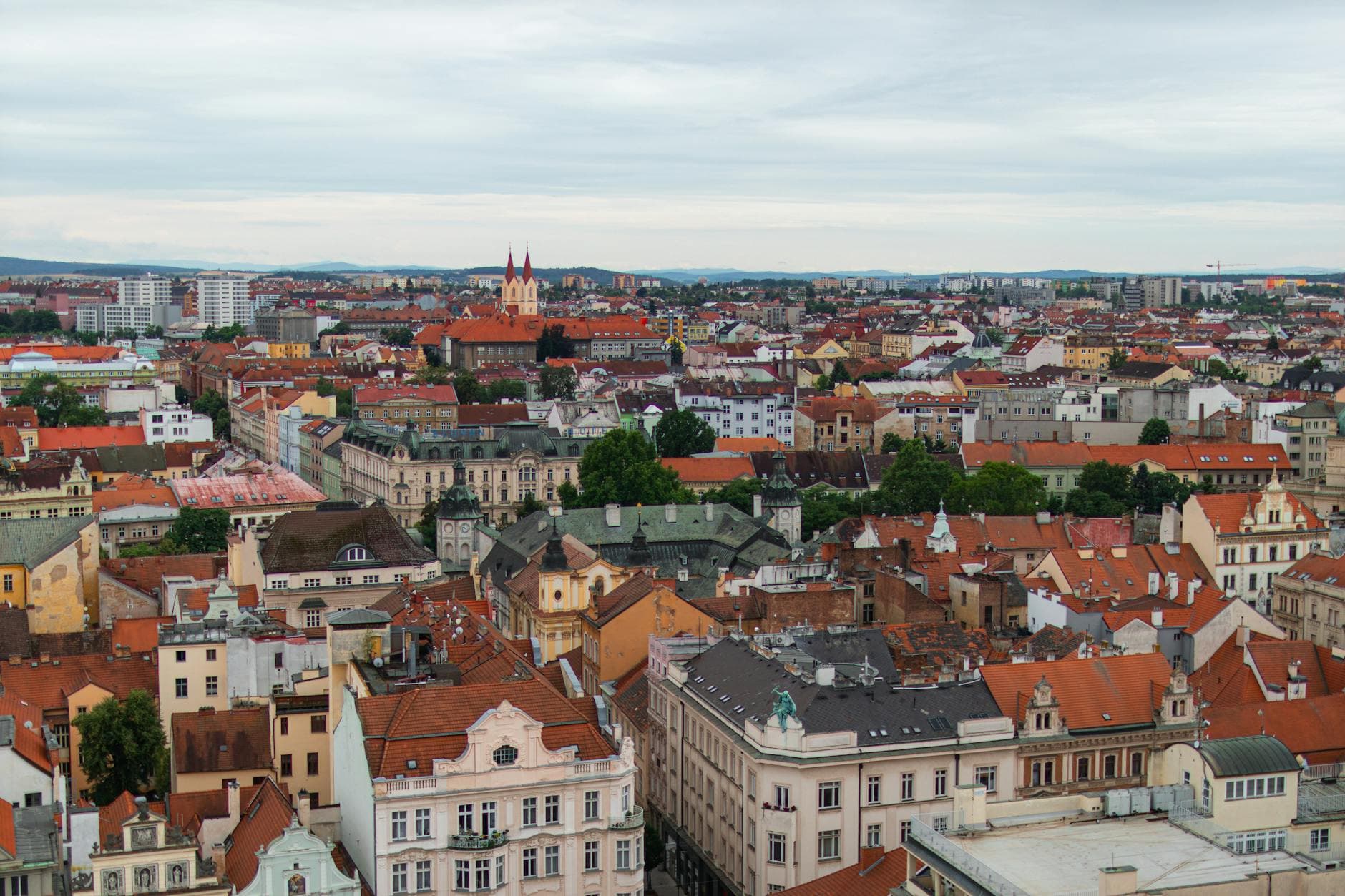 Aerial view of vibrant rooftops and architecture in Plzeň, Czech Republic, showcasing historical charm.
