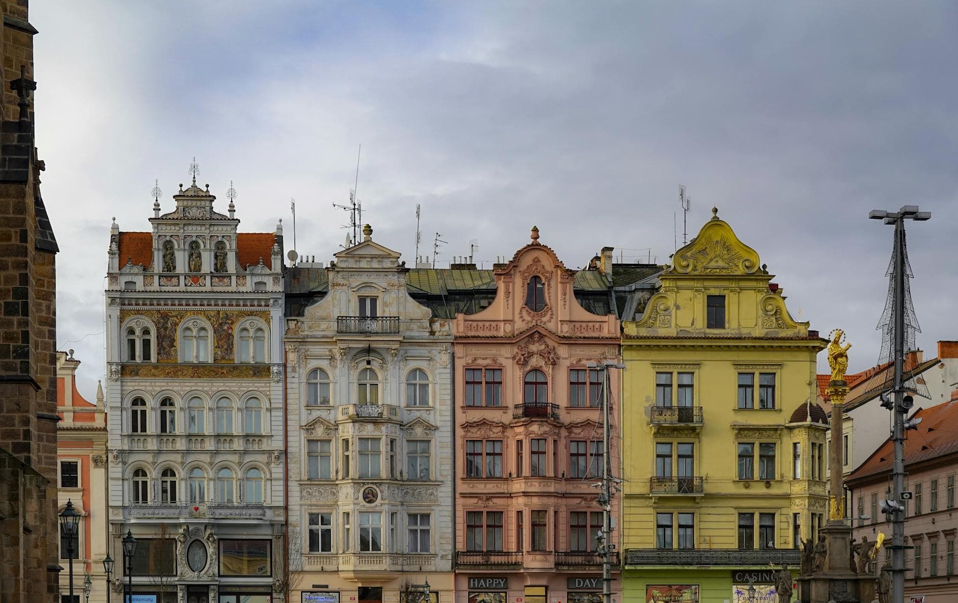 Vibrant Renaissance-style facades line a street in Pilsen, Czech Republic, showcasing architectural beauty.