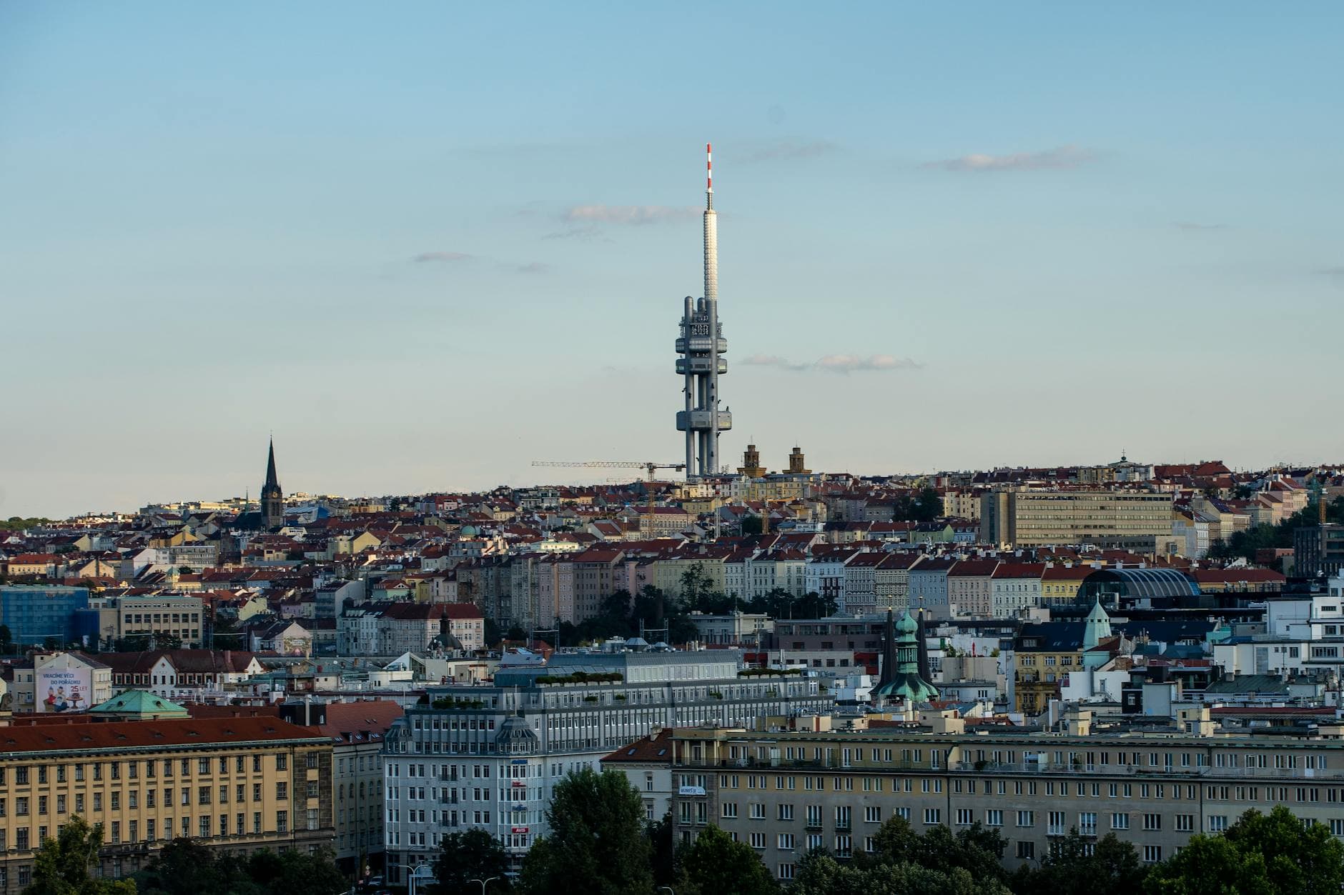 Aerial view of Prague cityscape featuring the iconic Žižkov Television Tower.