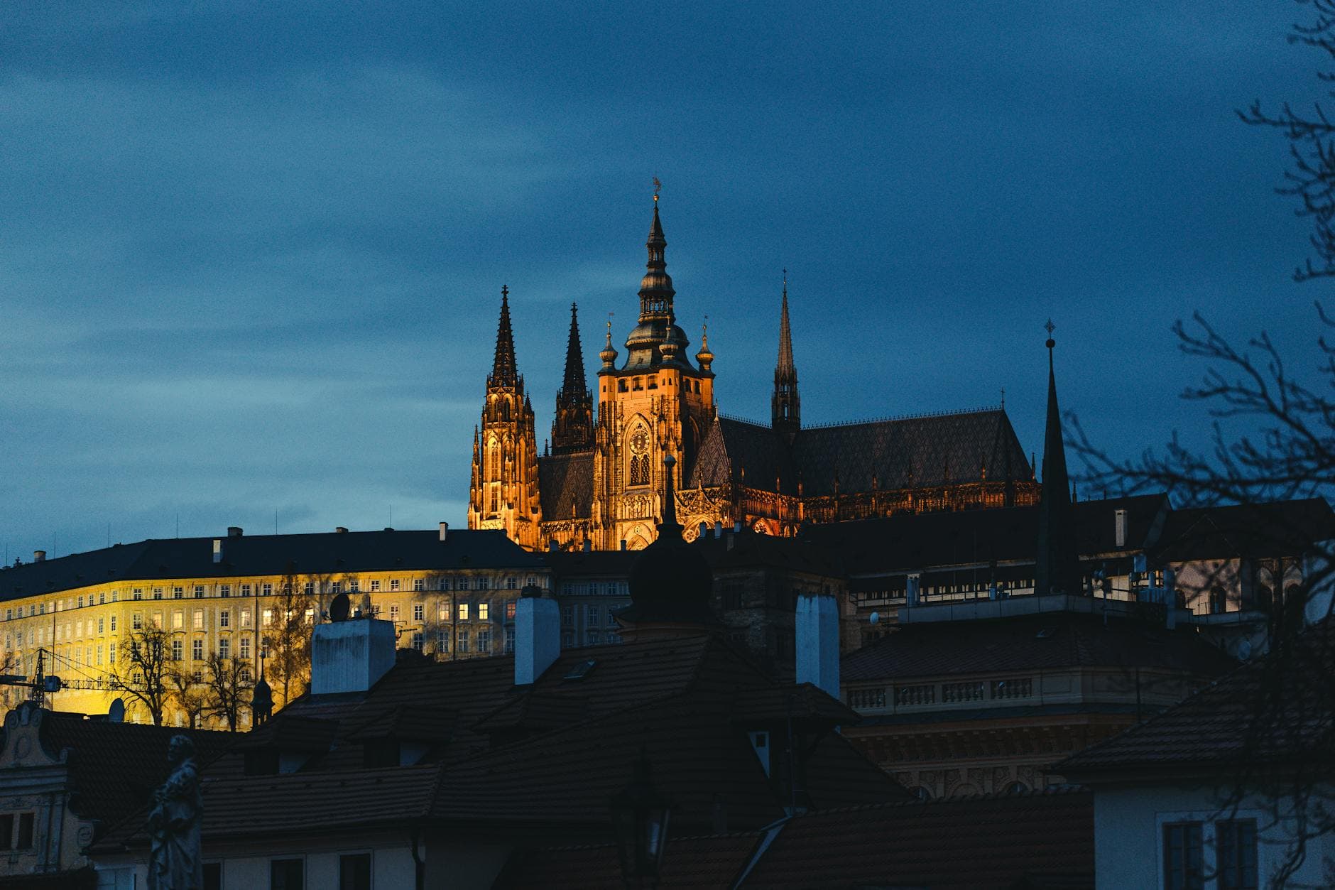 A mesmerizing view of Prague Castle glowing against the evening sky, a must-see landmark in the Czech Republic.