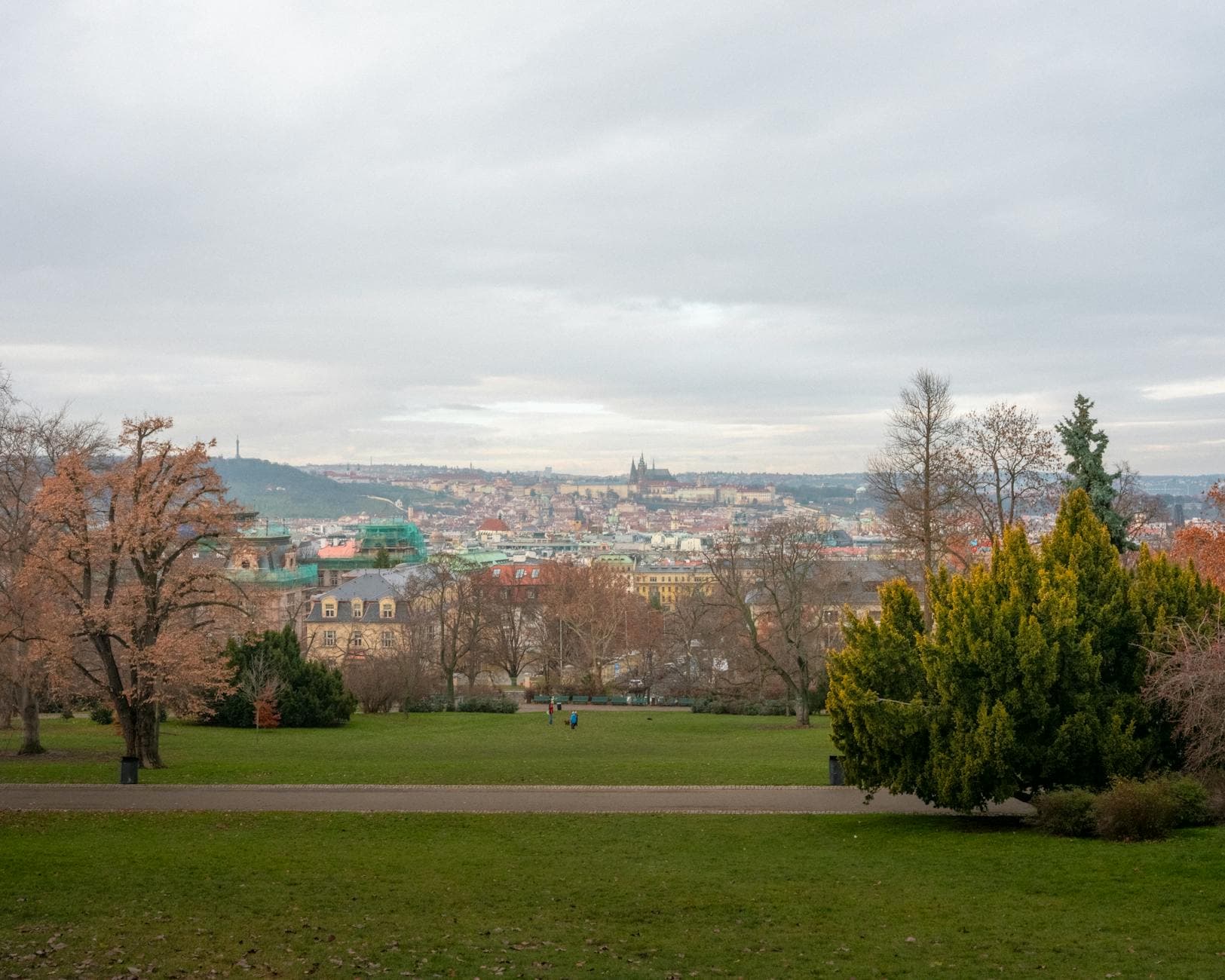 Scenic view of Prague's skyline captured from Letná Park during a cloudy day in autumn.
