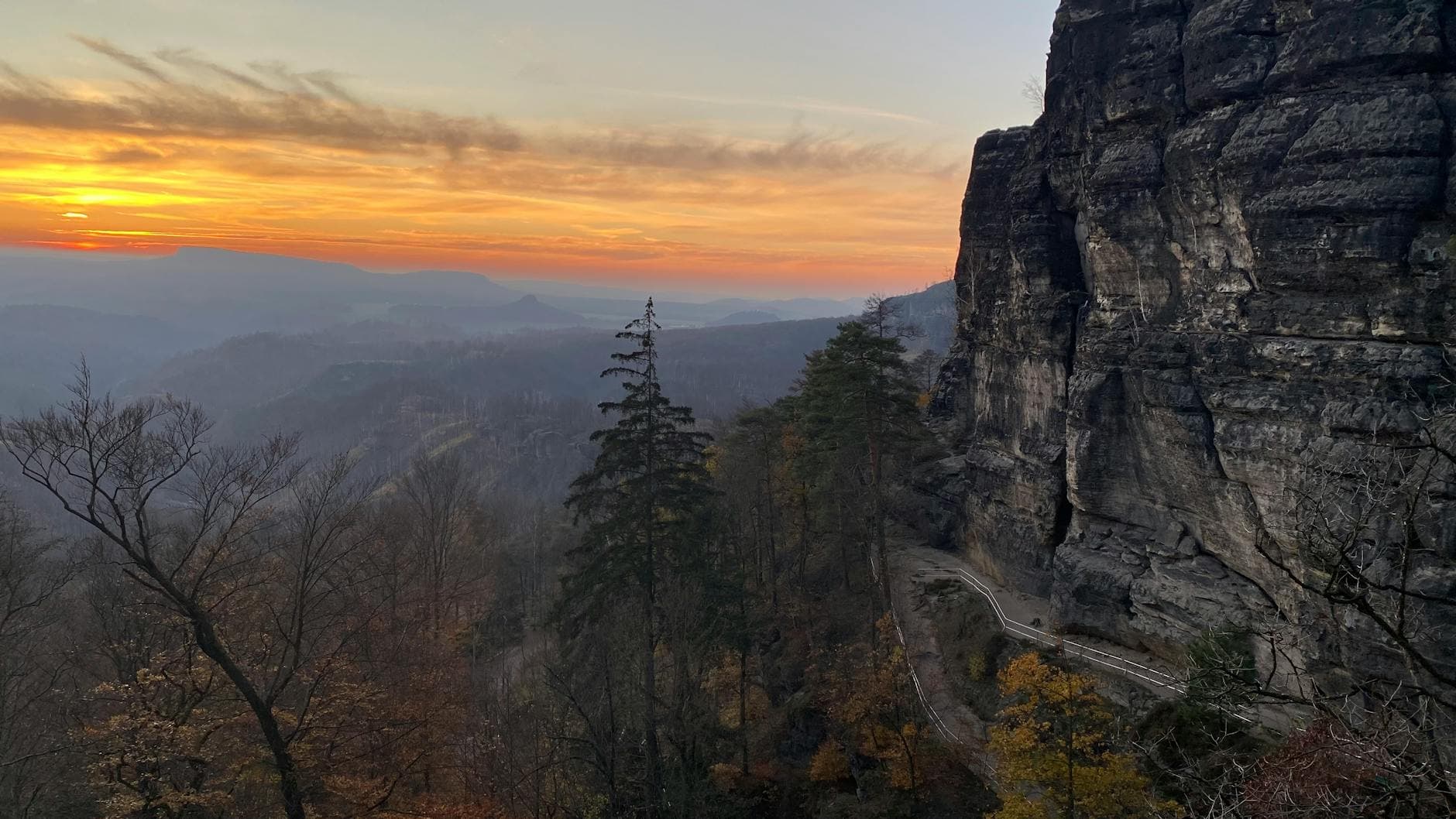 Dramatic sunset over the scenic cliffs and valley in Bohemian Switzerland National Park.