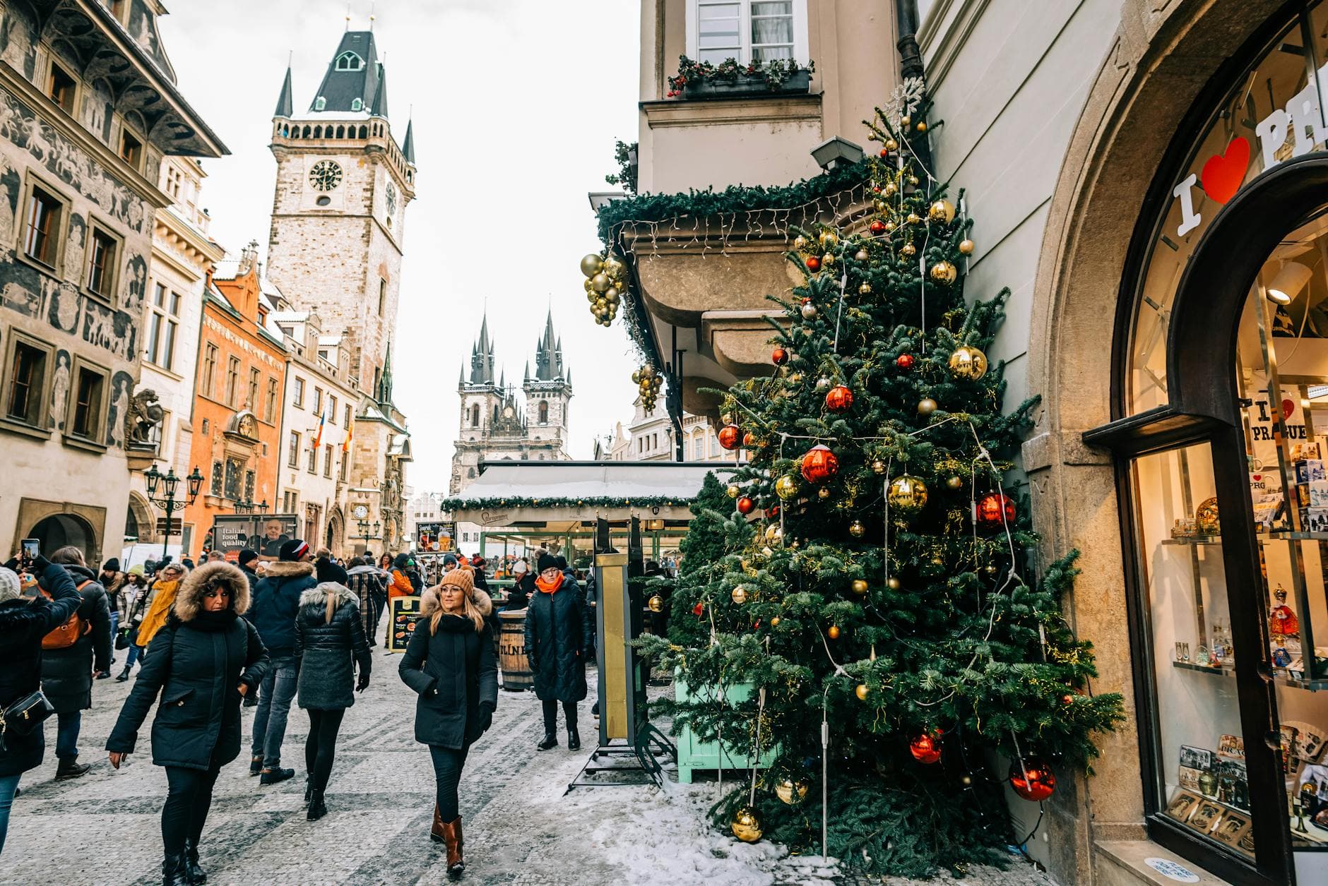 Vibrant Christmas market in Prague with festive decorations and historic architecture.