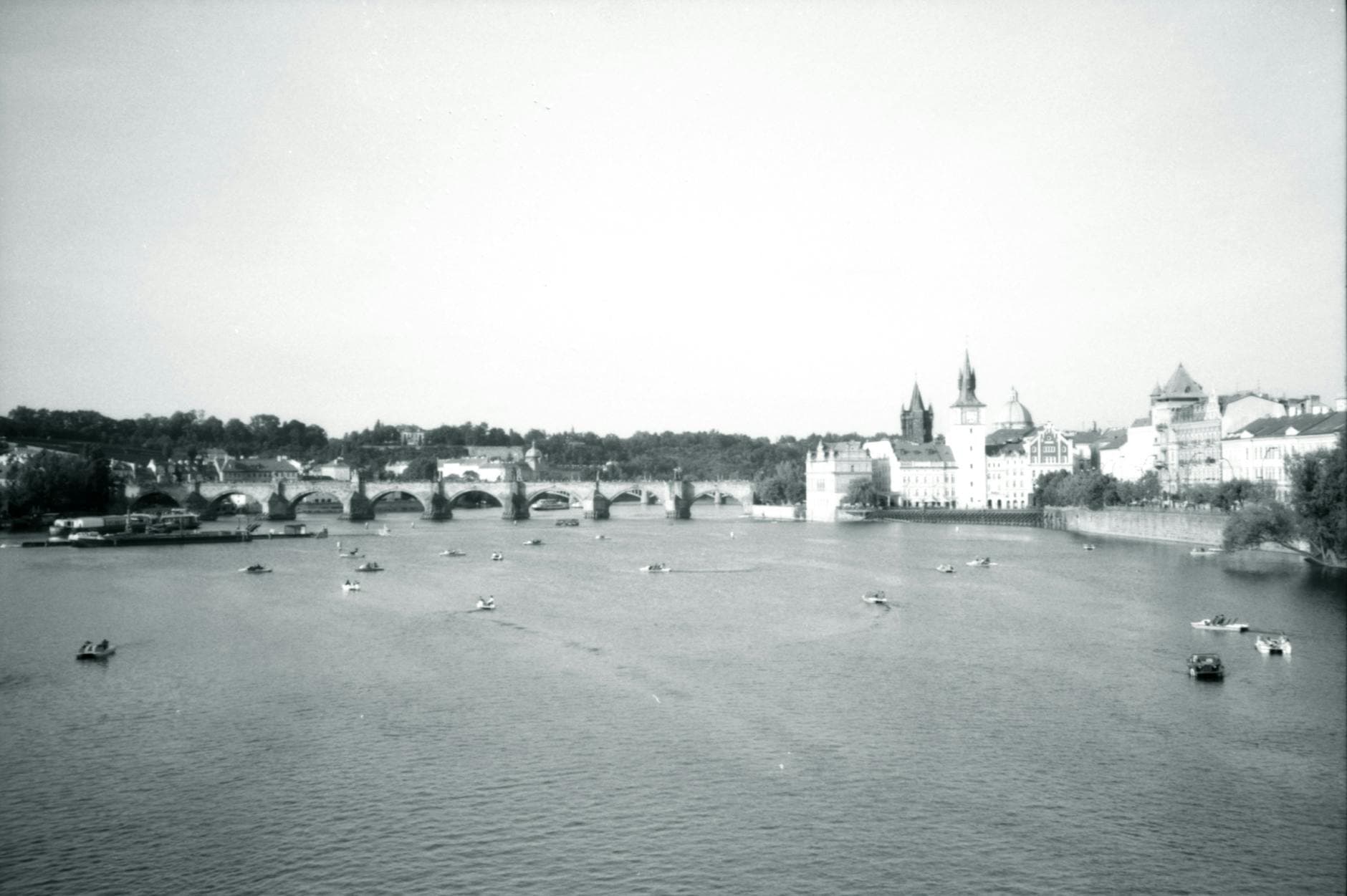 Black and white view of Charles Bridge in Prague over the Vltava River. Iconic Czech landmark.