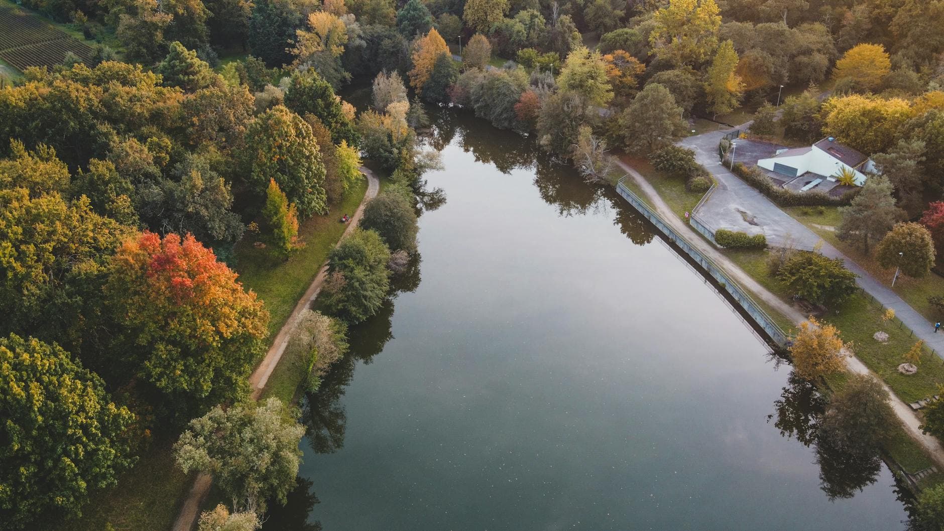 Scenic aerial view of an autumnal park and lake in Bordeaux, France.