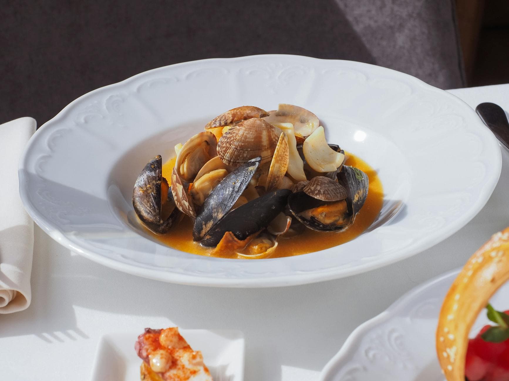 A delectable gourmet dish featuring mussels and clams in a savory sauce, perfect for seafood lovers.
