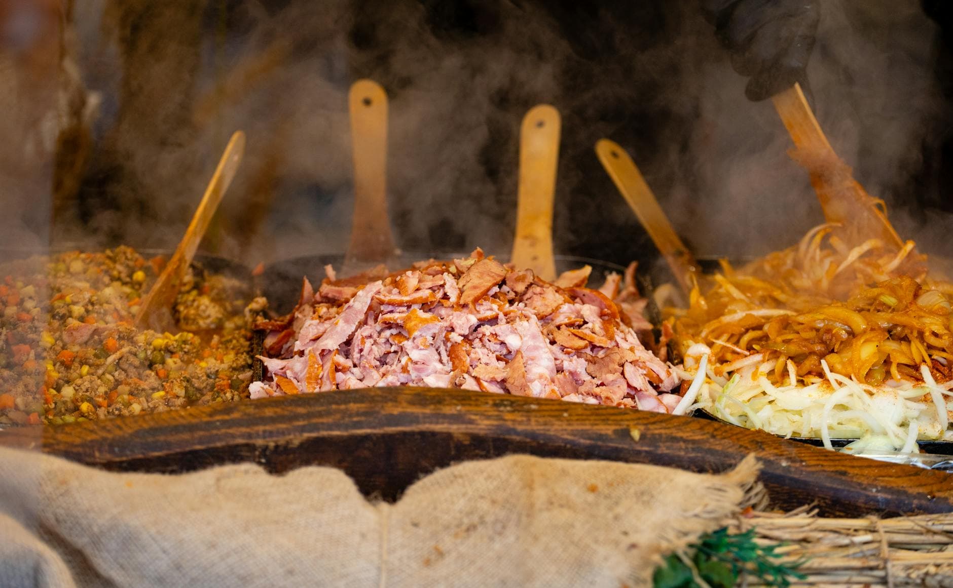 Steam rises from a variety of sizzling street food dishes, perfect for a hearty meal.