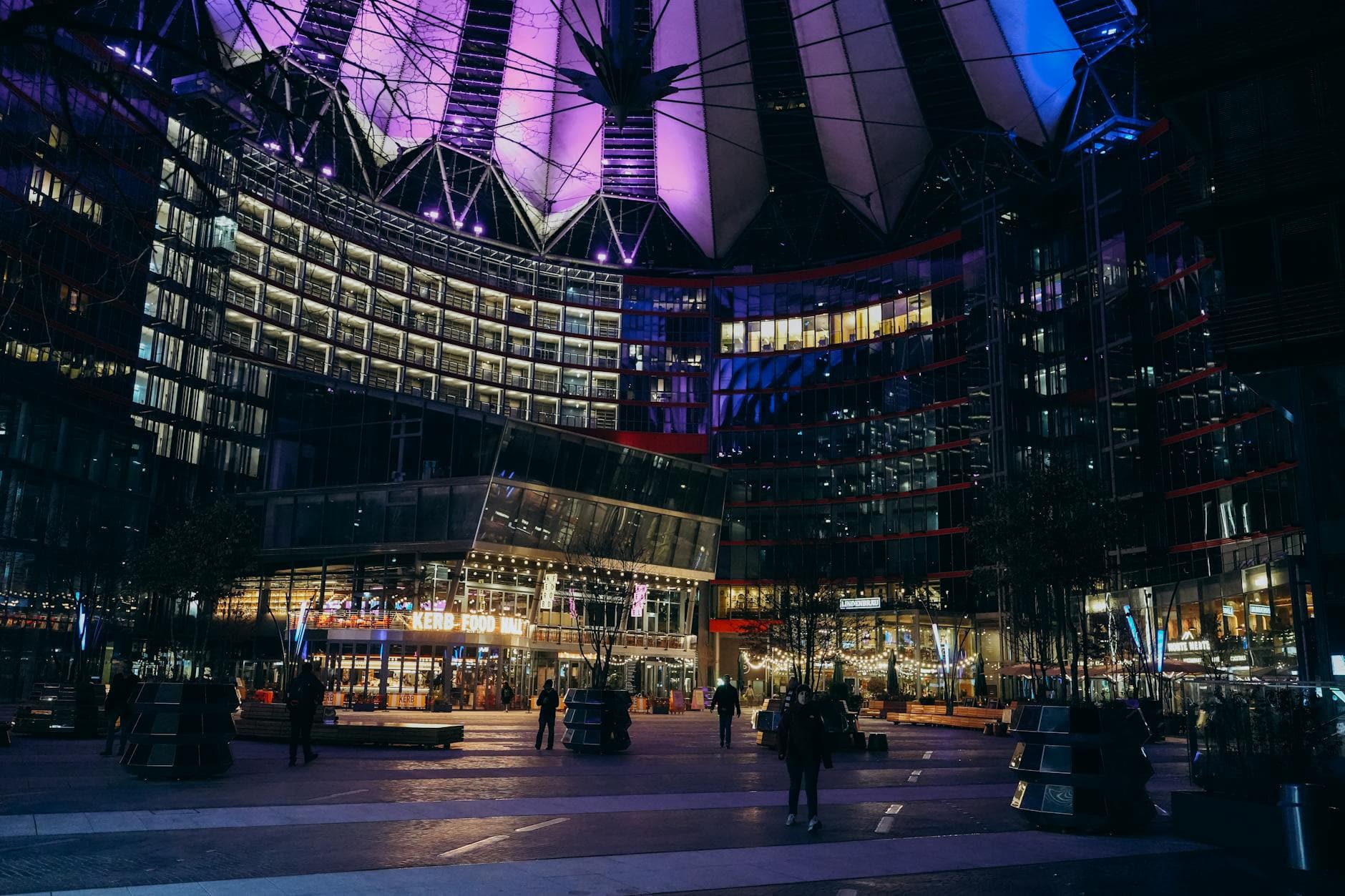 Night view of the Sony Center with vibrant lights and modern architecture in Berlin.