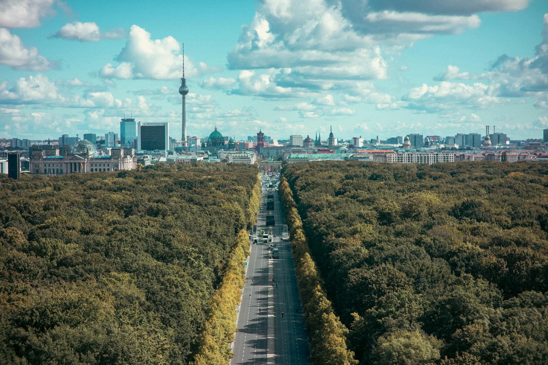 Aerial view of Berlin's skyline and Tiergarten with TV tower on a bright day.