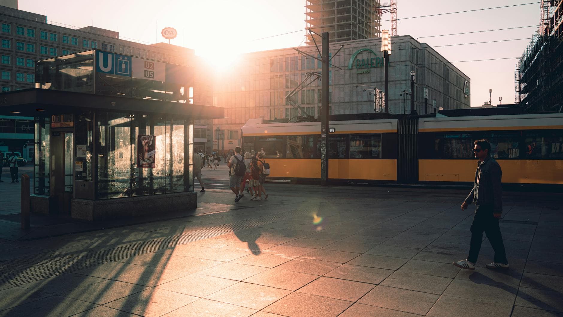 Vibrant sunset at Alexanderplatz, Berlin showcasing urban life and architecture.