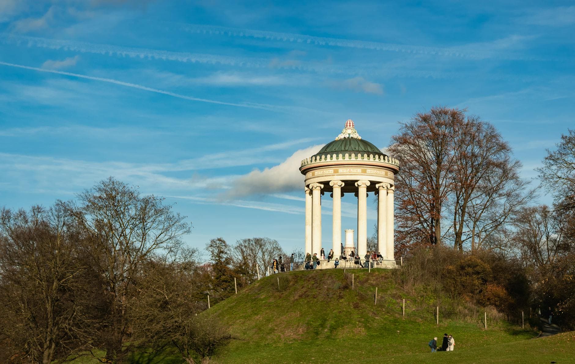 View of the Monopteros Temple in Munich's English Garden on a sunny day.