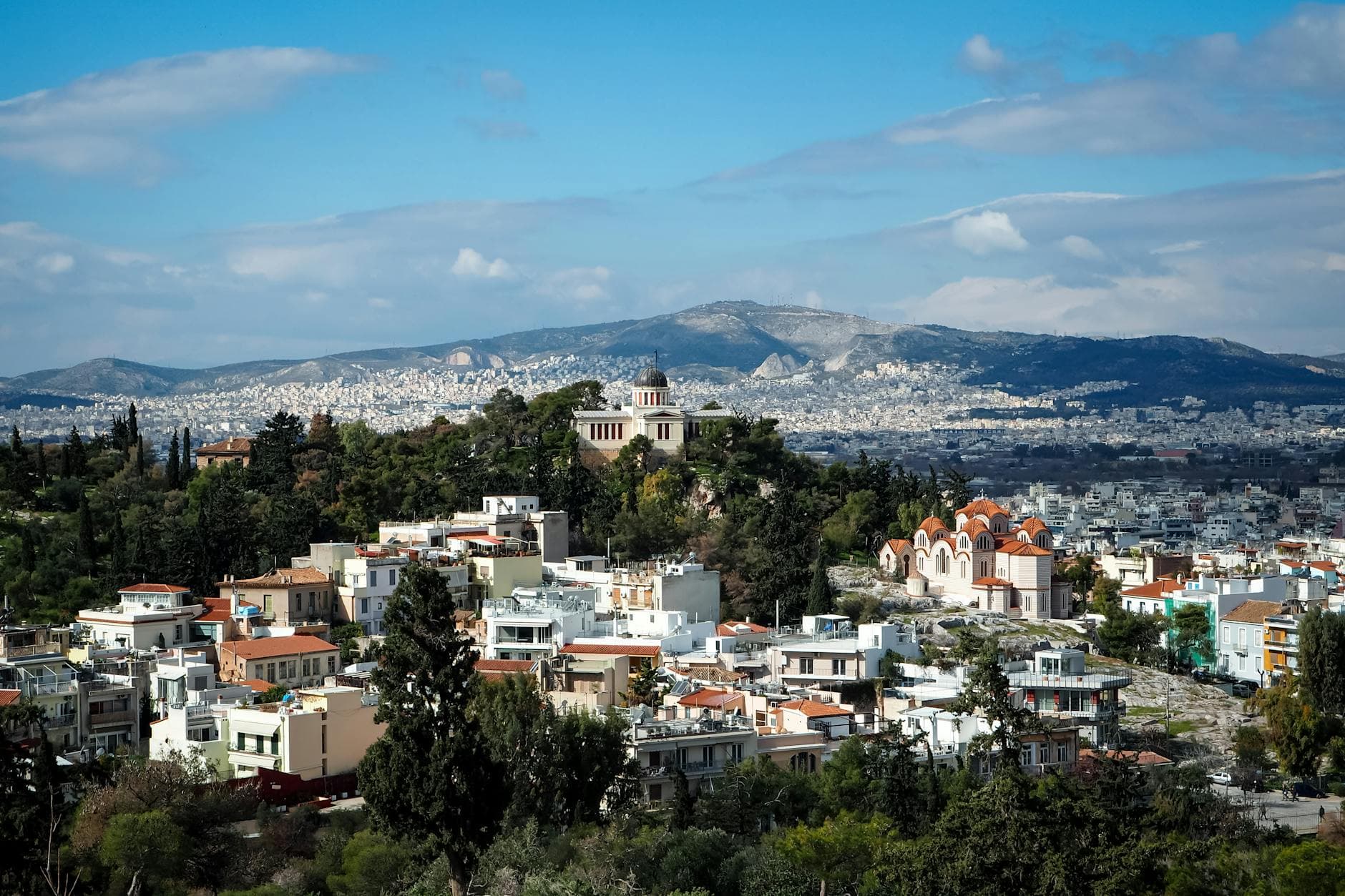 Explore a stunning aerial view of Athens, featuring vibrant landscapes and iconic architecture.
