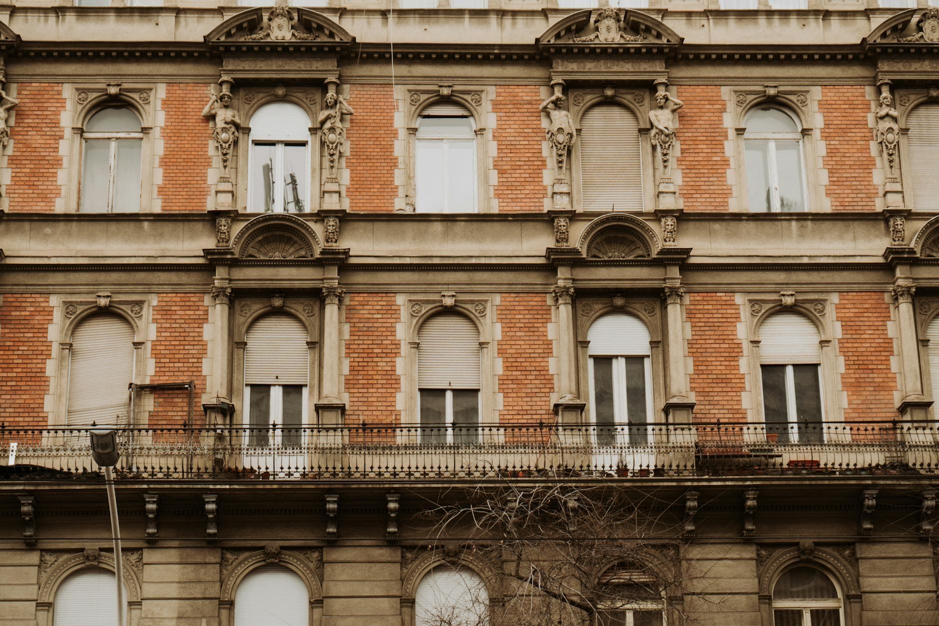 Detailed facade of a historical building with classical architecture in Budapest, Hungary.