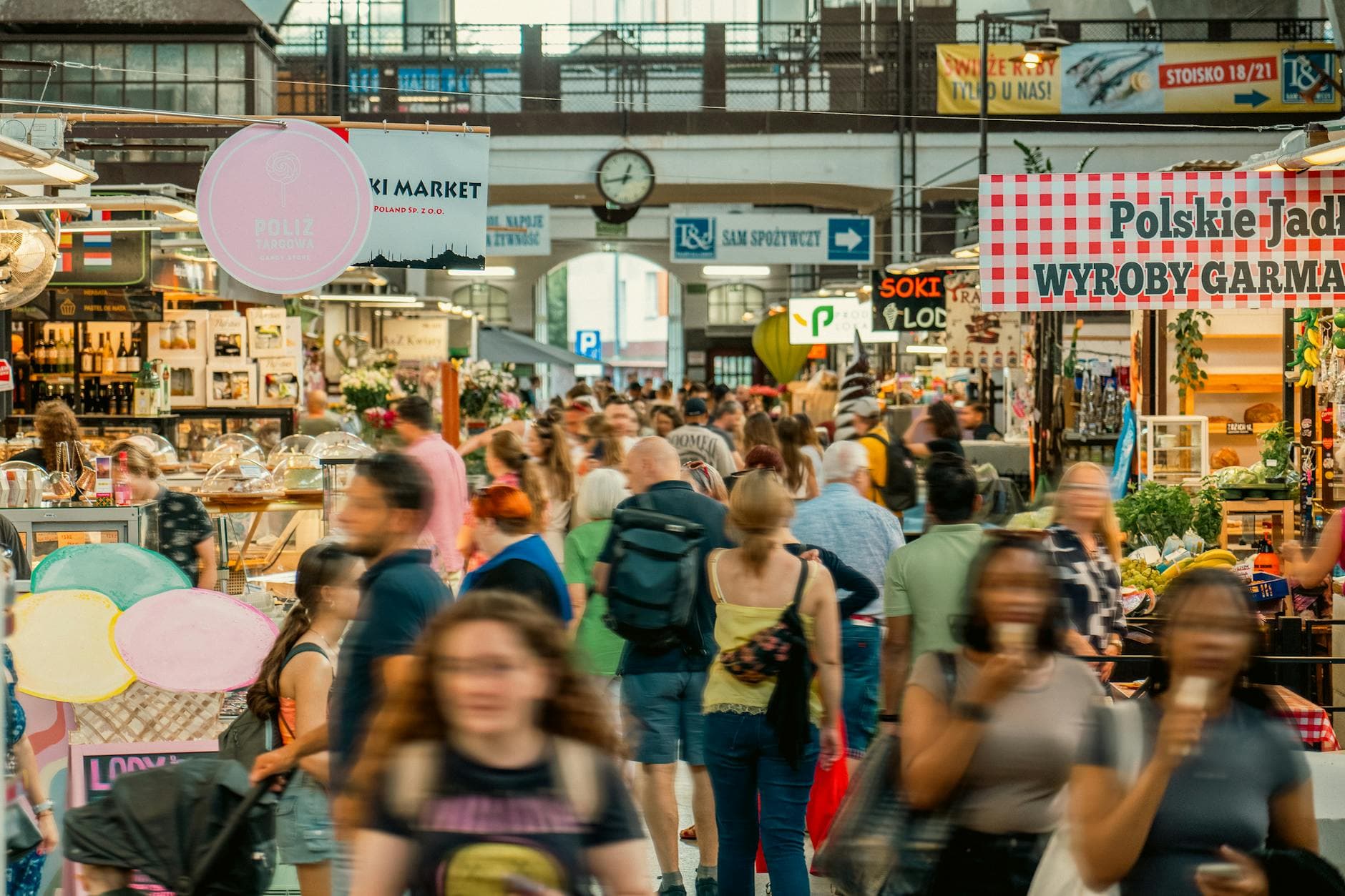 Explore the vibrant Wrocław indoor market with people shopping and local stalls.