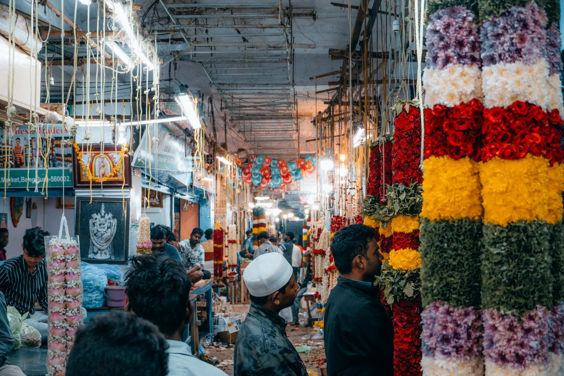 Explore the vibrant and bustling flower market in Bengaluru, India, featuring colorful floral garlands and local vendors.