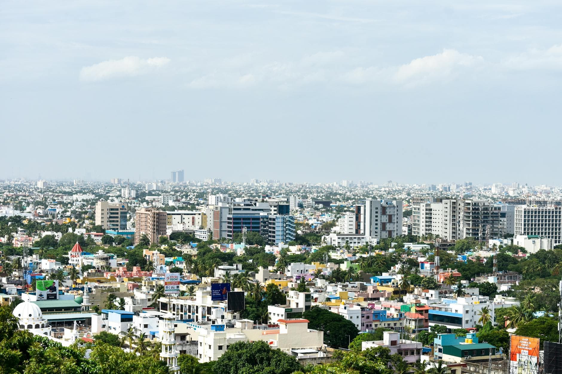 Aerial view of colorful high-rise buildings in Chennai, India, under a clear sky.