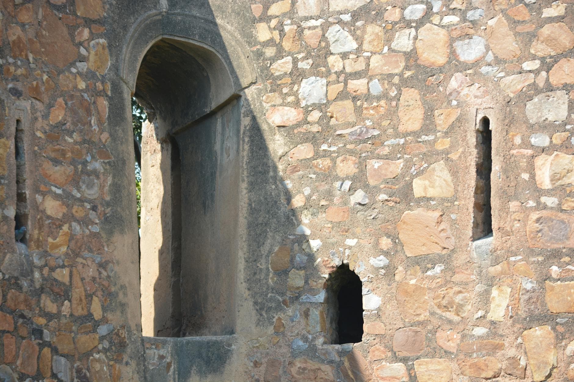 Close-up of stonework at Firoz Shah Kotla Fort in Delhi, showcasing ancient architecture.