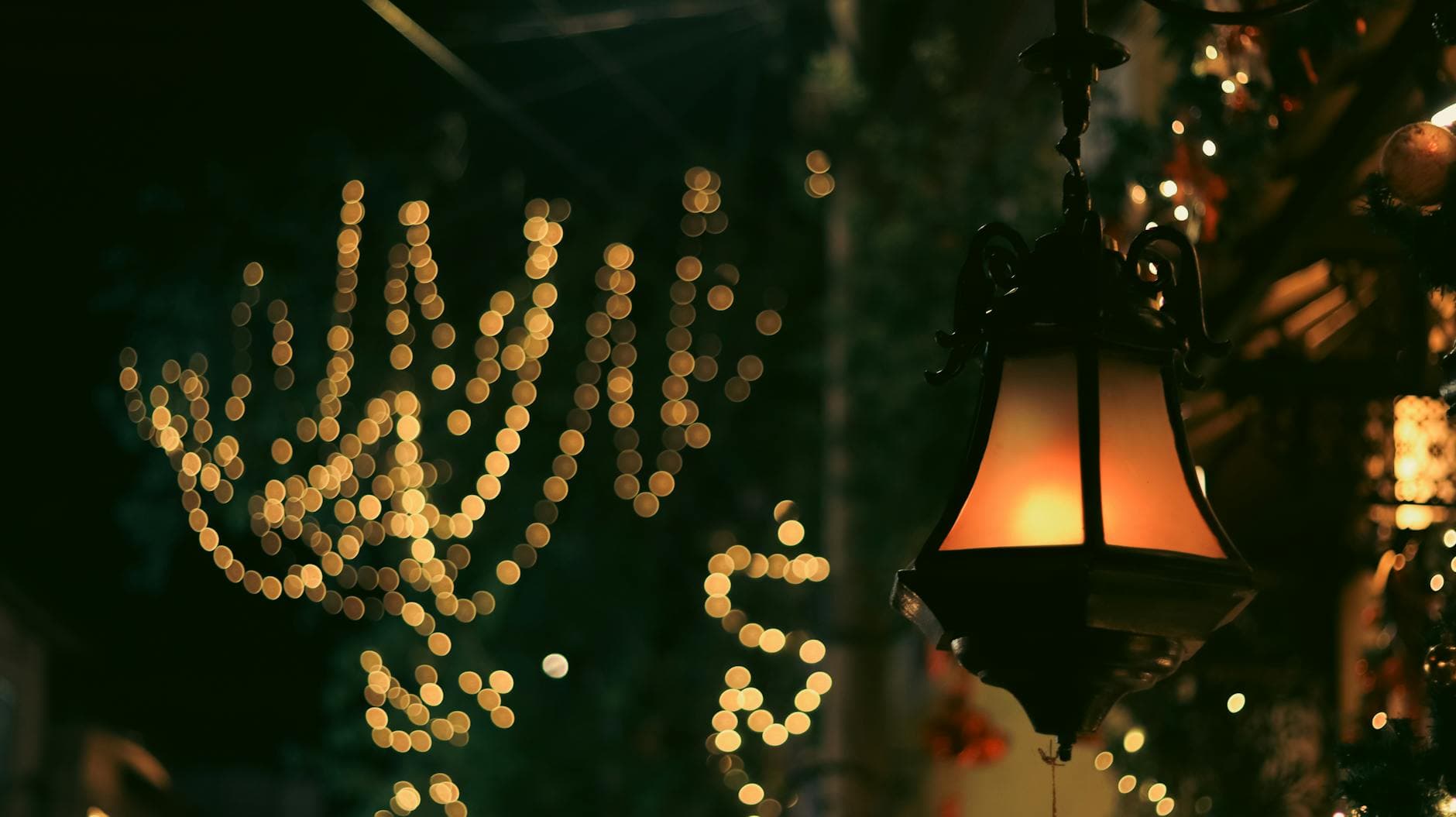 Elegant street lantern and festive bokeh lights on a night street in Kochi, India.