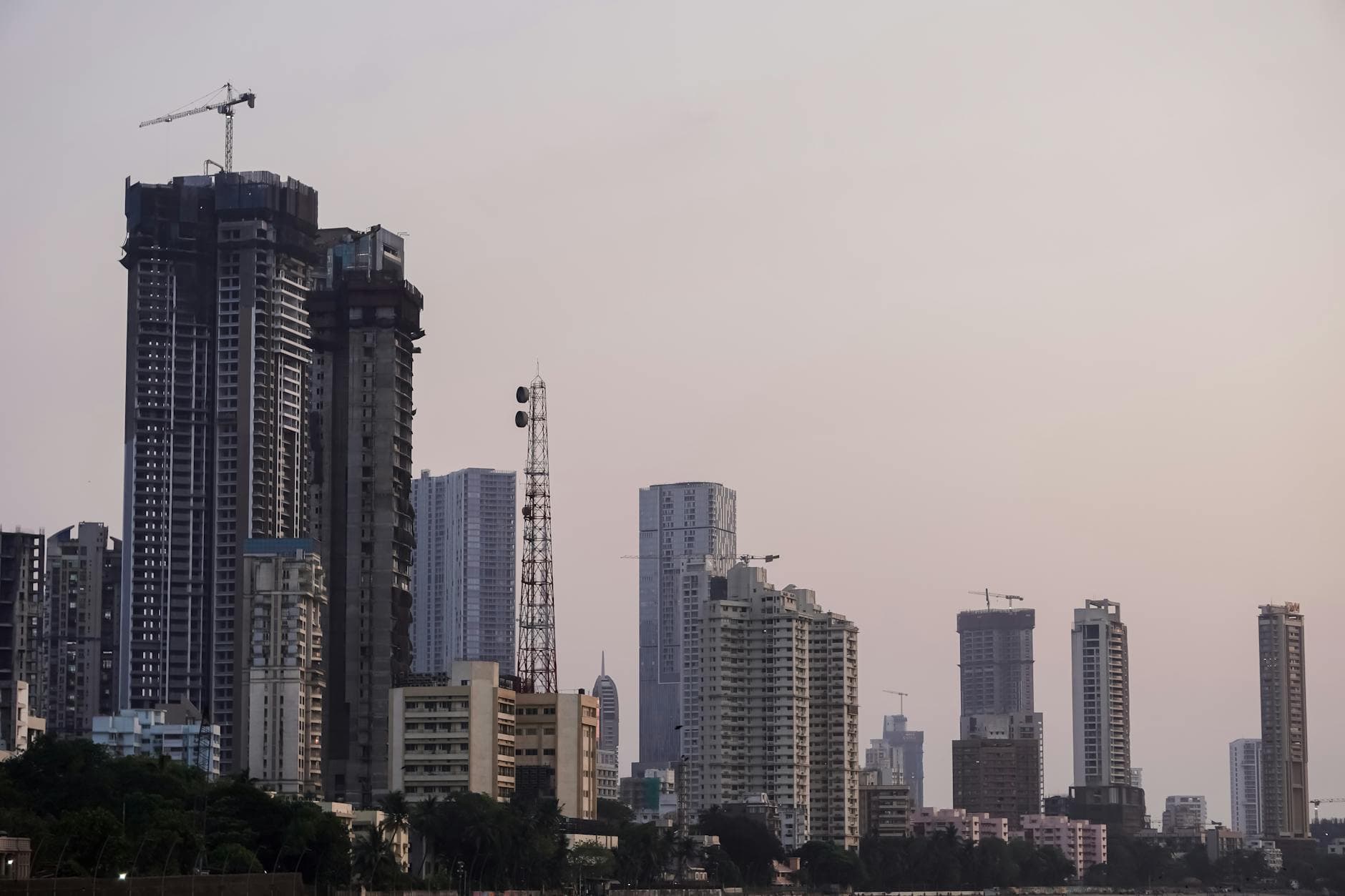 Twilight view of Mumbai's skyline showcasing tall buildings and a serene evening ambiance.